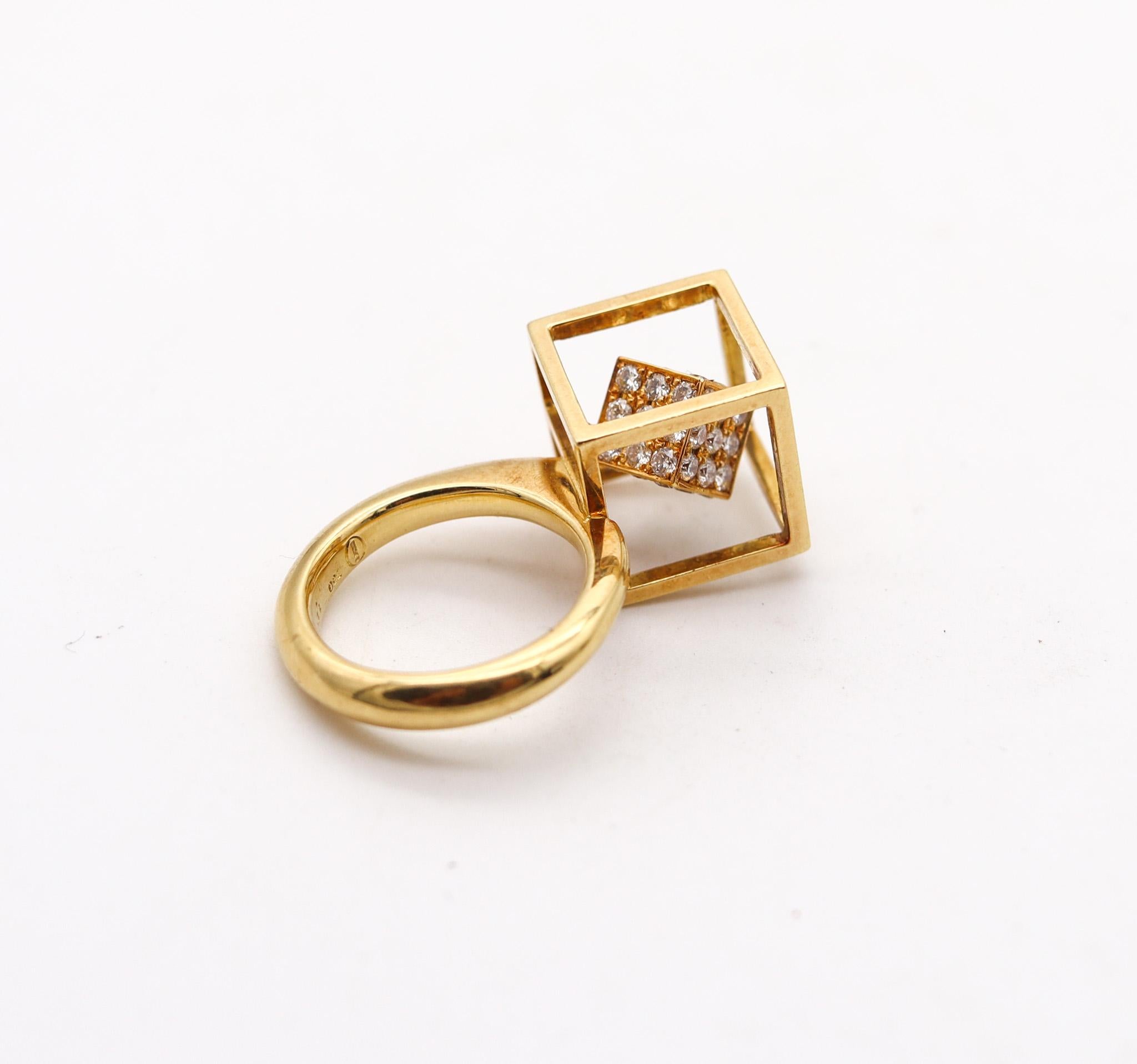 Sculptural op-art ring with diamonds.

An sculptural cocktail ring, created with op-art motifs. It was crafted in three dimensions in solid yellow gold of 18 karats with high polished finish. The design composed by a floating cube embellished with
