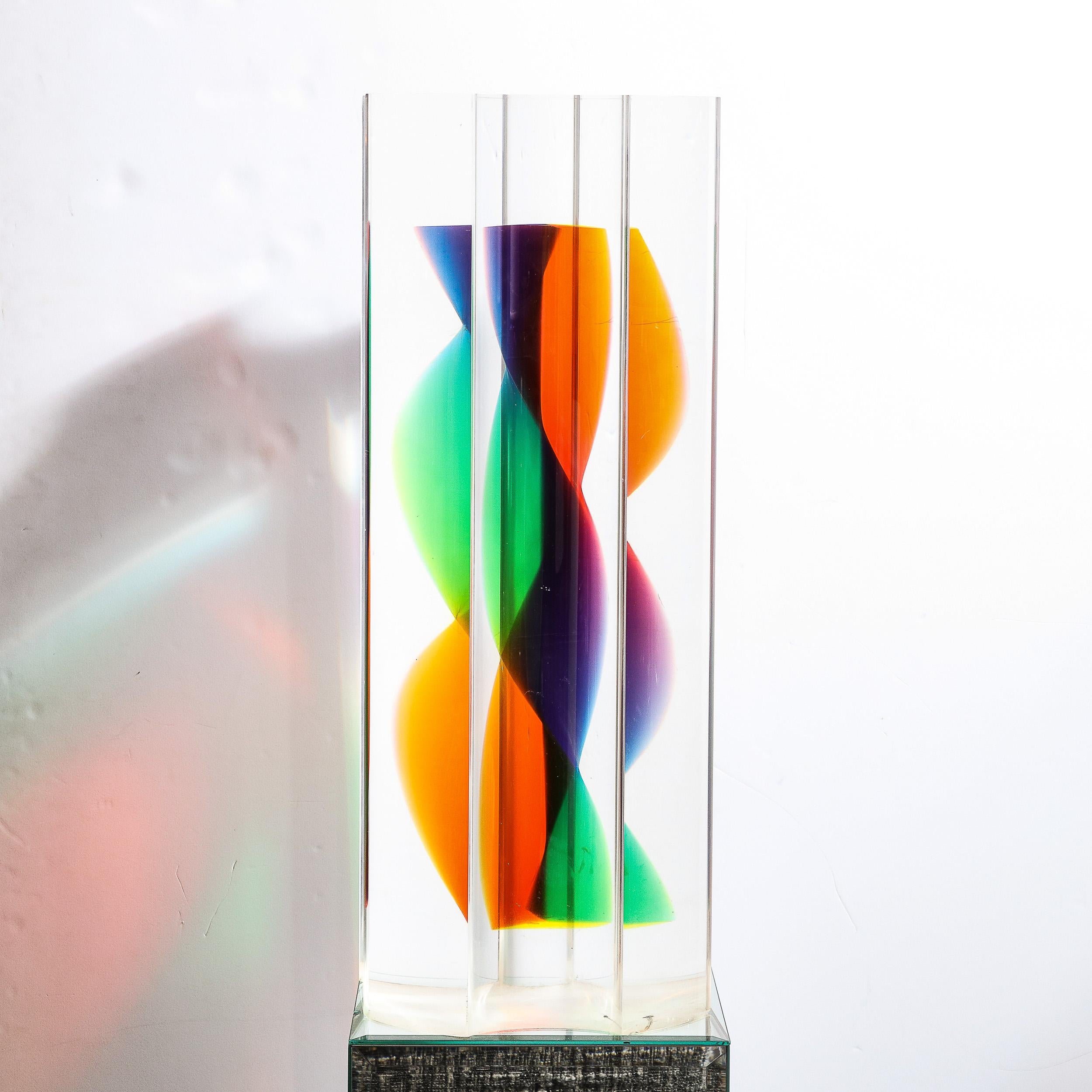 This stunning modernist polychromatic caste acrylic abstract sculpture was realized by the esteemed artist Norman Mercer in the United States circa 1990. It features a volumetric cylindrical form with a demilune depressions creating a scalloped