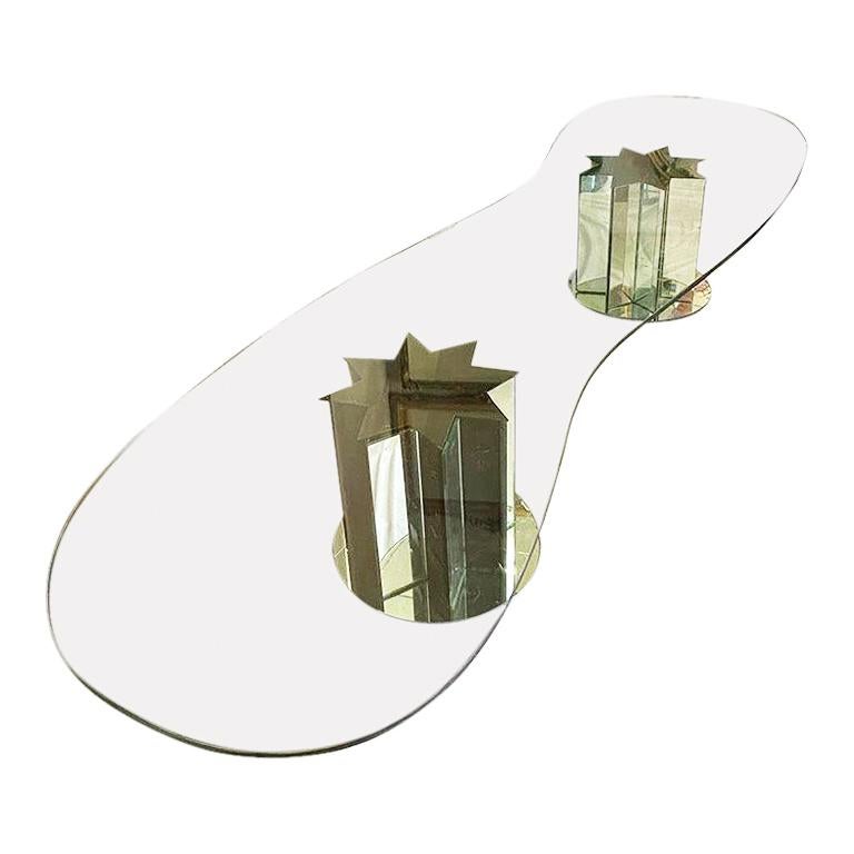 Low modernist serpentine glass coffee or cocktail table with two mirrored twin star-shaped bases. This fabulous cocktail table is an excellent example of early 20th century design. The glass stop is extremely heavy and thick and can be described as