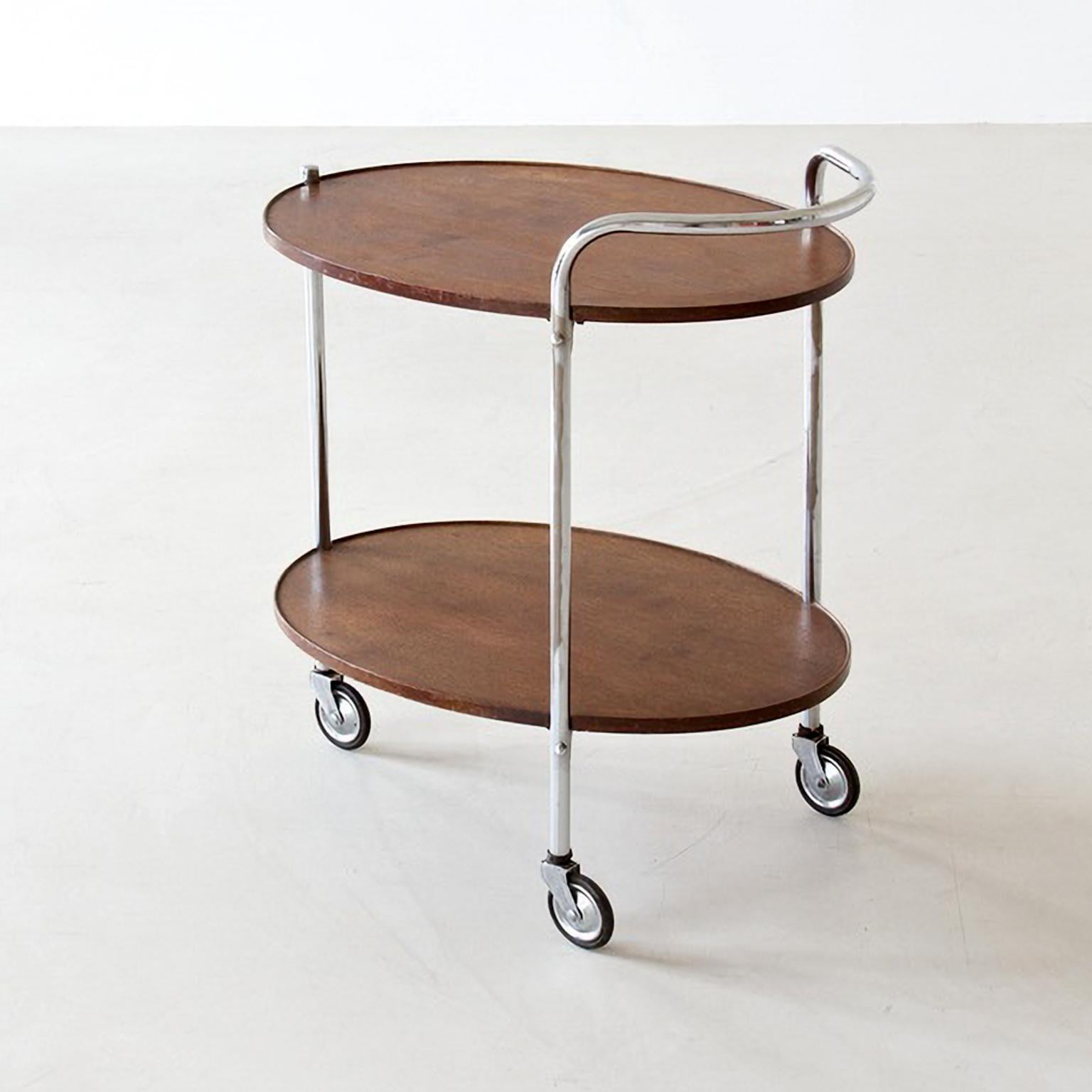 Modernist serving trolley with two oval wooden shelves, chromed metal, circa 1930.