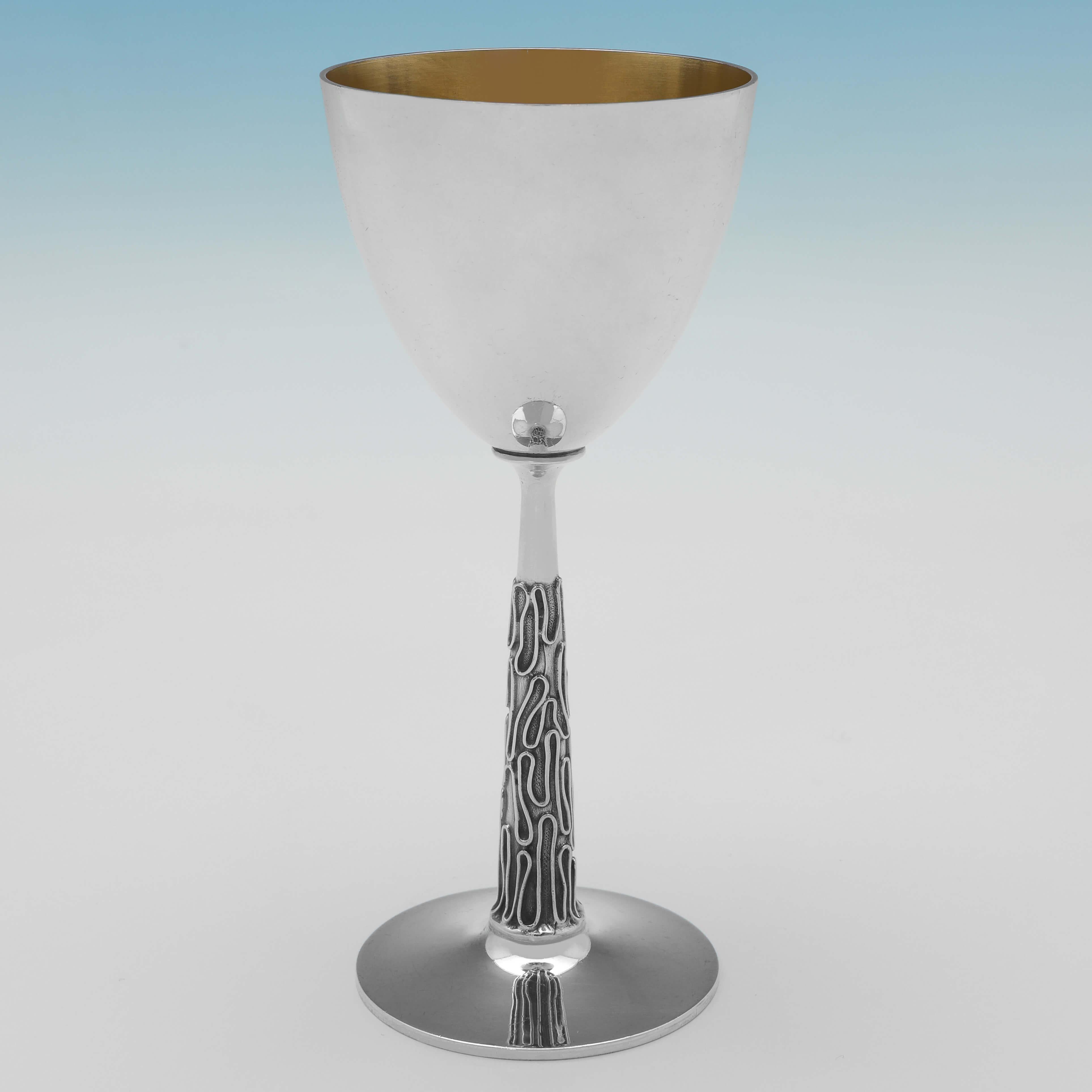 Hallmarked in London in 1978 by George Edward Grant, this stylish set of 8 Modernist design, Sterling Silver Goblets, features textured stems, and gilt interiors. 

Each goblet measures 6.75
