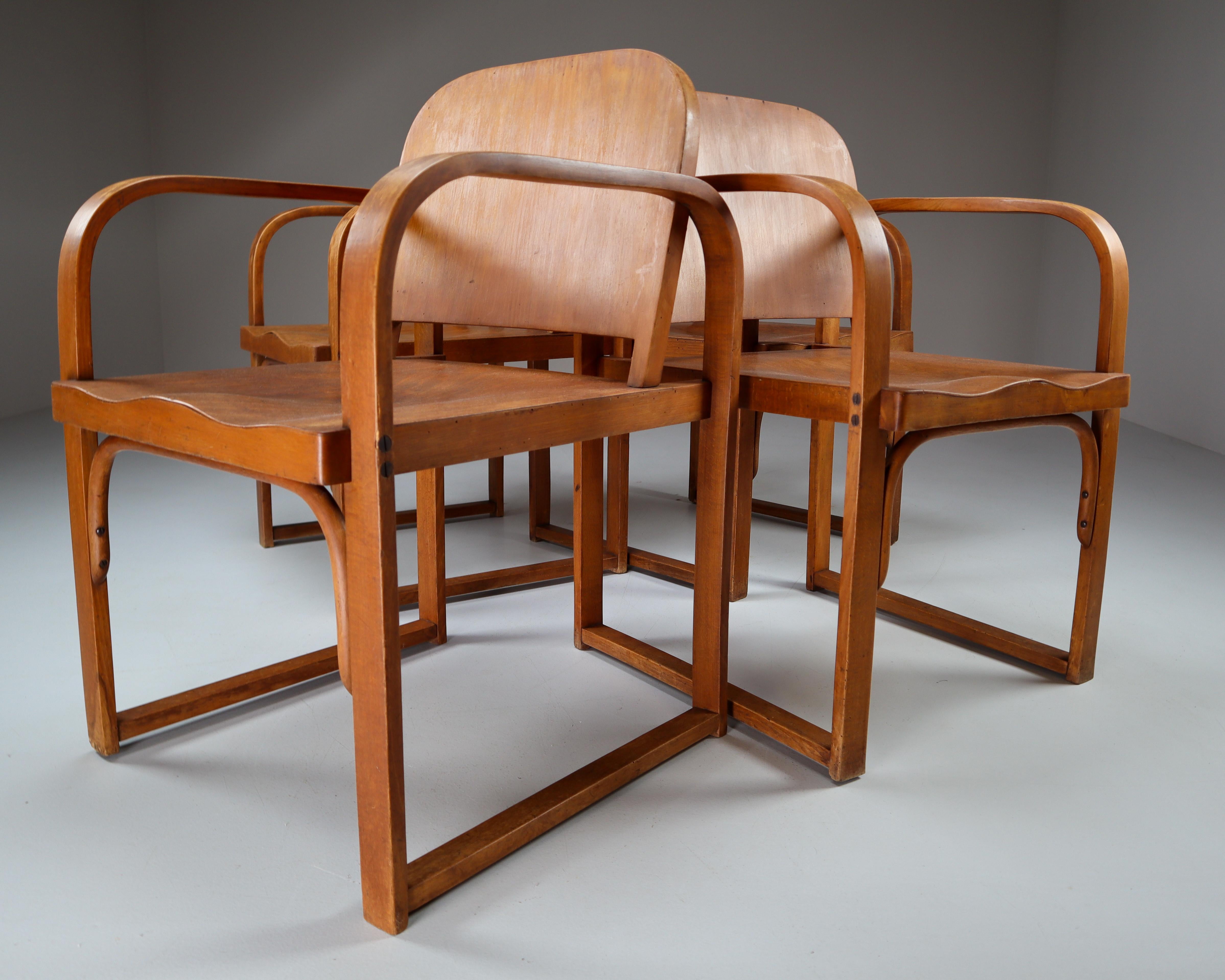 Modernist set of four armchairs made by Tatra in 1930s. The chairs are built of sharp, geometric lines with rounded corners. The armrests are made of bent technology, the chair seat is gently ergonomically shaped. The chairs are made of bent,