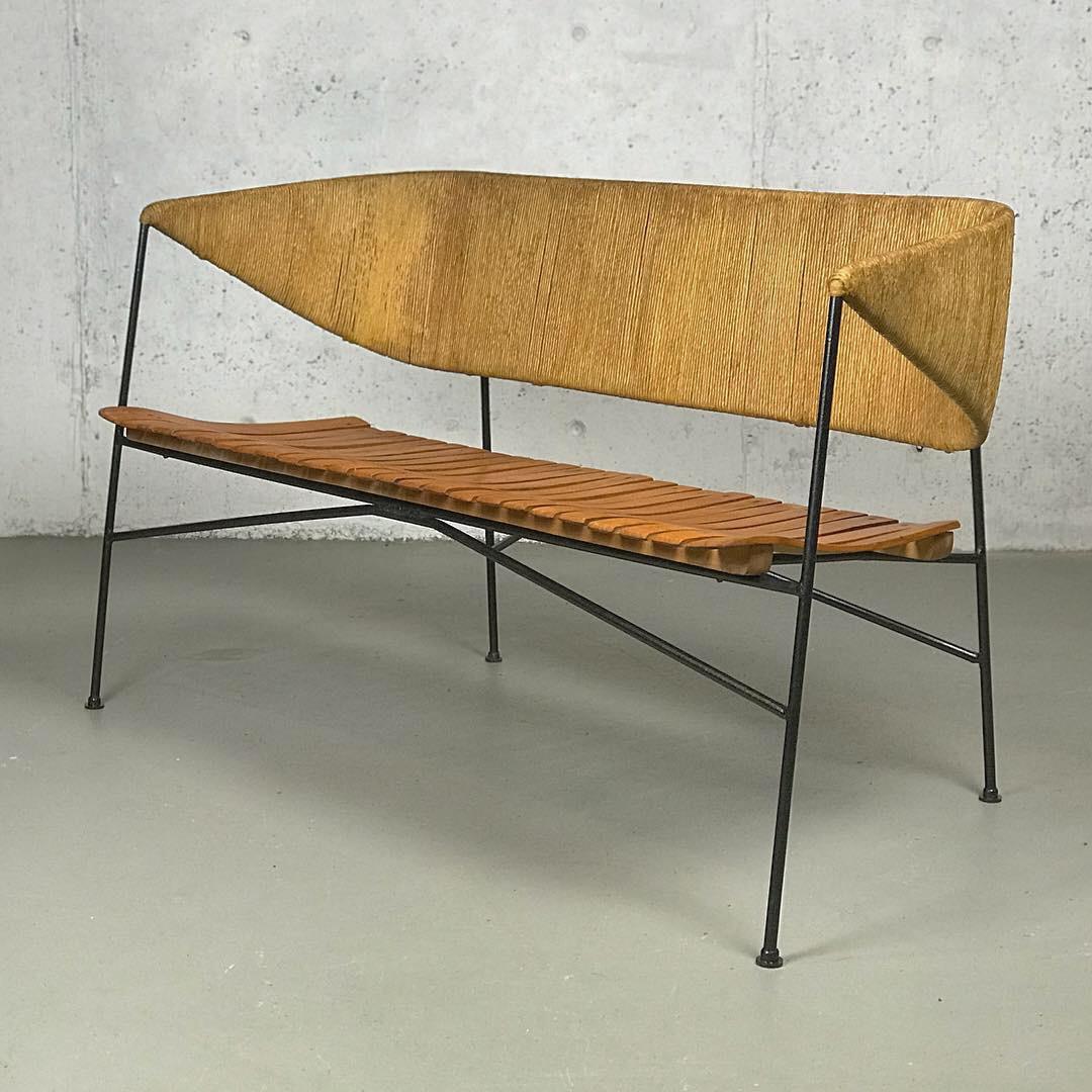 An exceptional example of museum-quality American Modern design from the 1950s - beautiful Minimalist settee designed by Arthur Umanoff for Shaver Howard and distributed by Raymor, in iron, wood & papercord. 
49