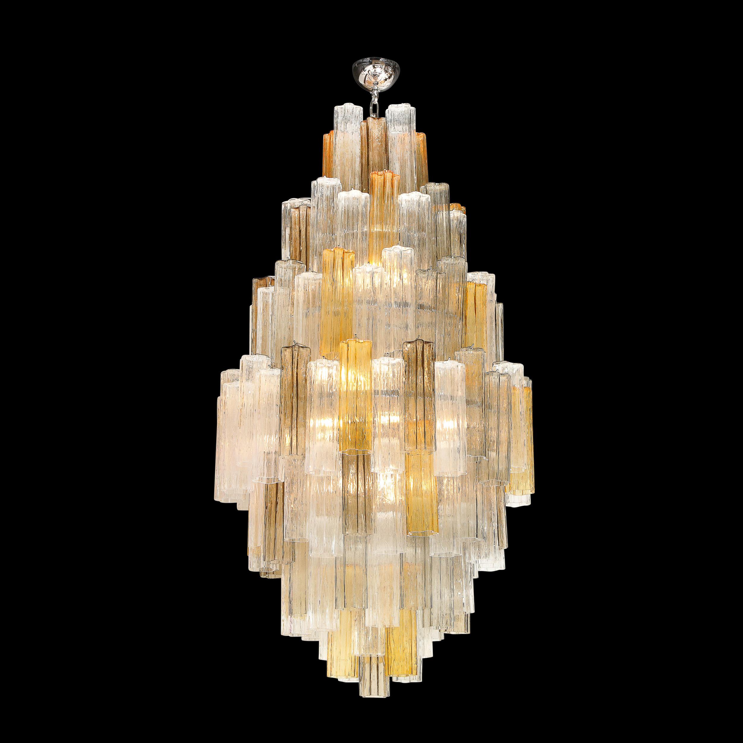 This stunning and vibrant modernist tronchi chandelier was handblown in Murano, Italy- the island off the coast of Venice renowned for centuries for its superlative glass production. It features an abundance of tronchi crystals in a Clear and Amber