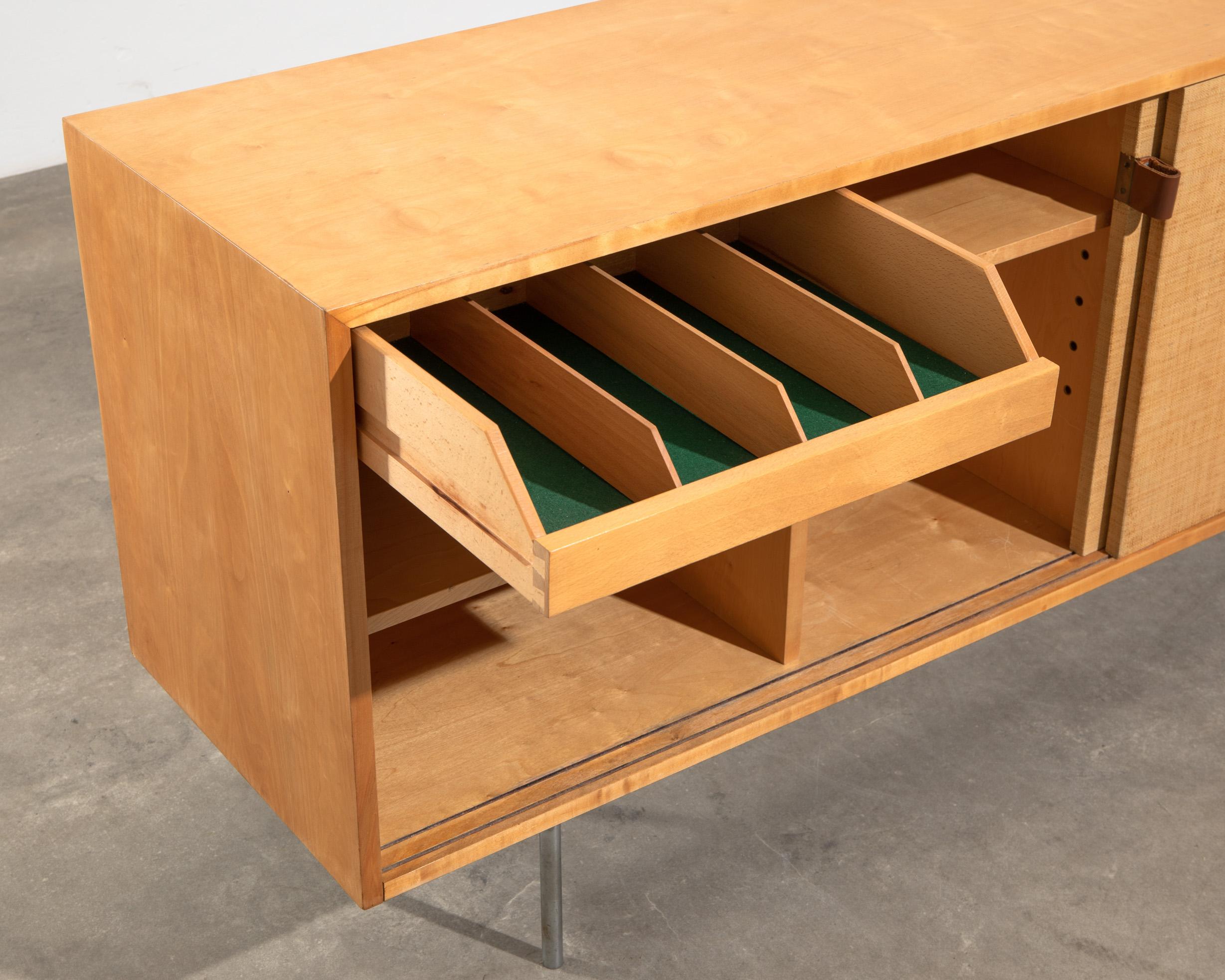 A classic modernist design sideboard by Florence Knoll, Model 116 for Knoll International - this version was produced in 1968 by Knoll International in Stuttgart. 

It features the typical sliding doors with Seagrass, wich was a popular detail also