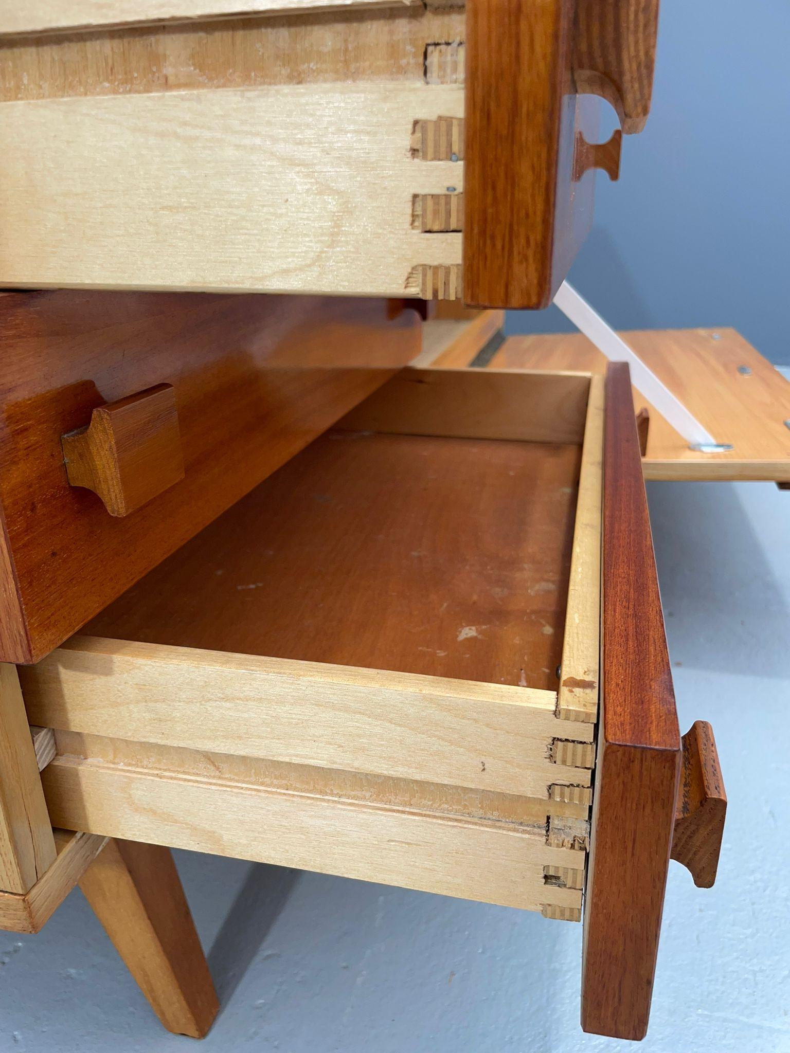 Ce buffet vintage a été produit en Tchécoslovaquie dans les années 1970 et présente le design moderniste fonctionnel typique de l'époque. D'après l'étiquette d'usine conservée, il a été fabriqué par Dřevotvar (Pardubice) et expédié le 6 janvier