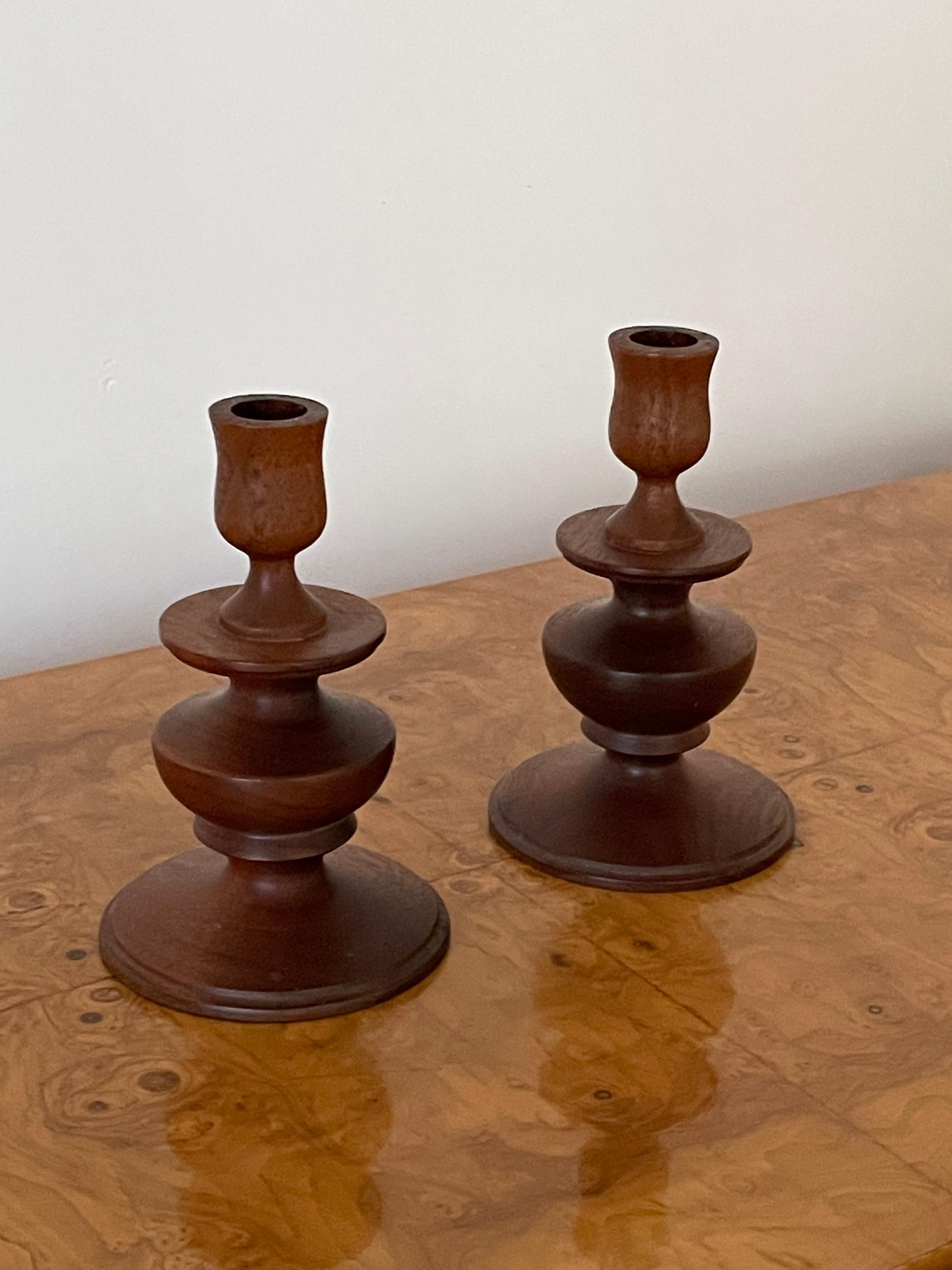 Pair of Modernist turned candle stick holders. On the bottom it reads 