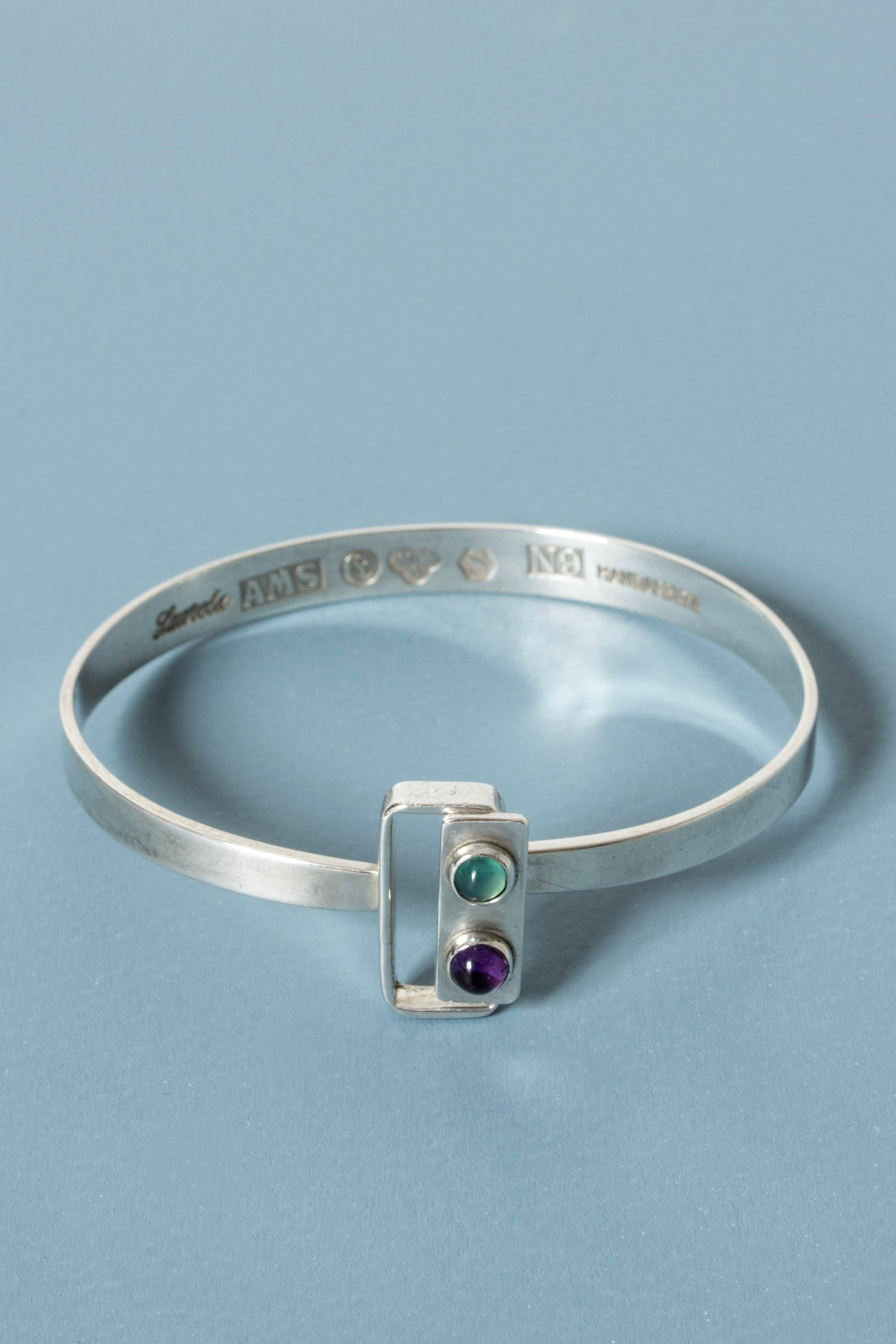 Lovely silver bracelet by Arvo Saarela, with two round cut amethyst and tourmaline stones on the clever lock. Neat and elegant.