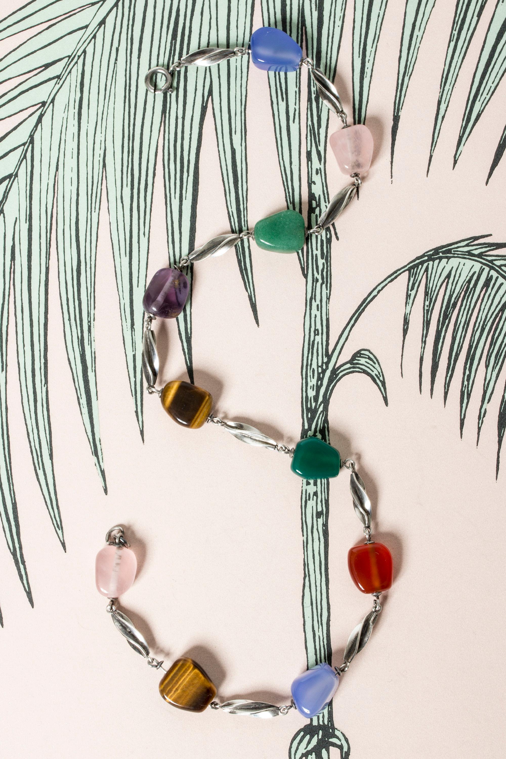 Beautiful midcentury silver collier, made of twirled silver sections alternating with semi-precious stones. Colorful and joyful! The stones are amethyst, chrysoprase, tigereye, chalcedony, aventurine, garnet and rose quartz.