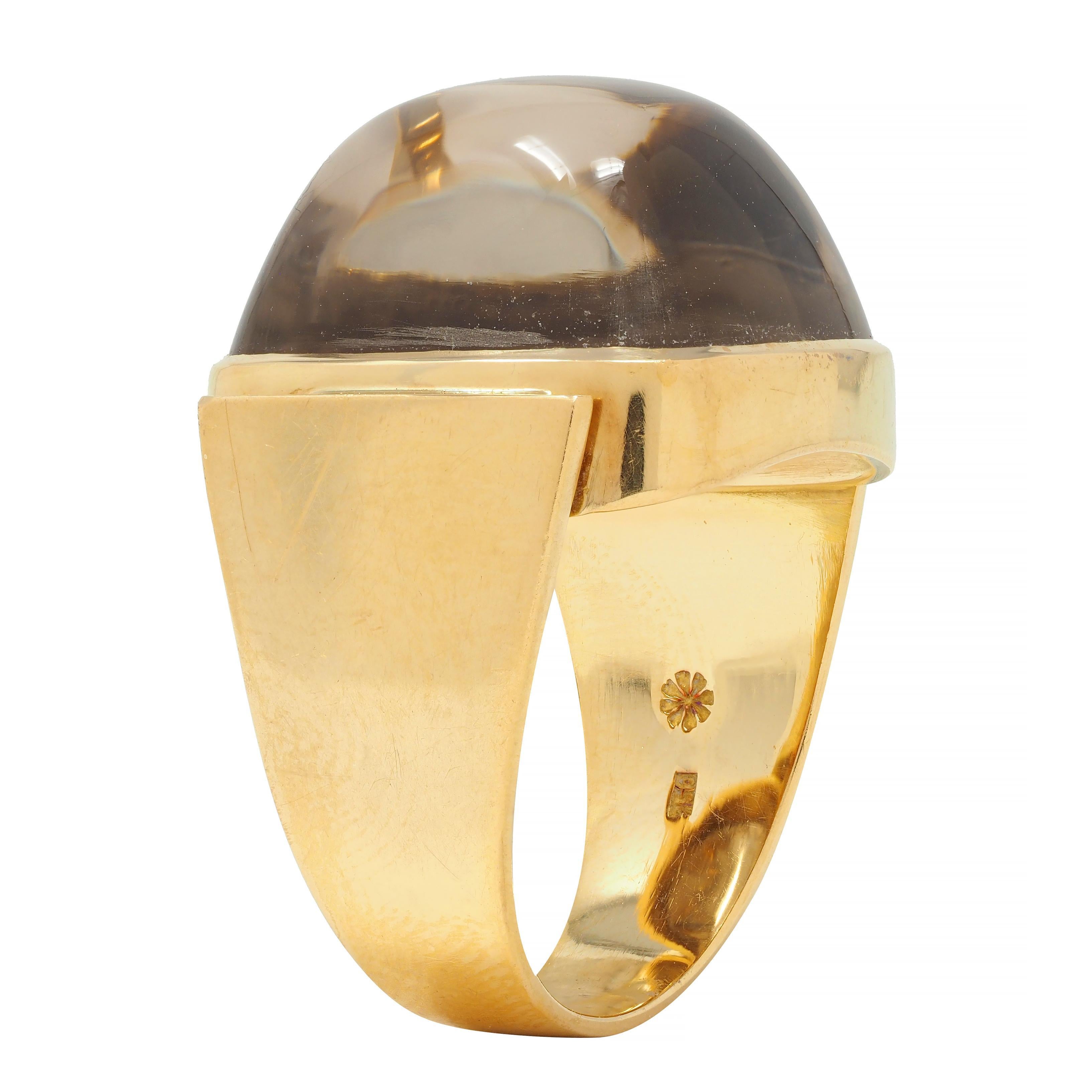 Centering a cushion-shaped sugarloaf cabochon measuring 17.0 x 19.0 mm 
Transparent, very light brown with subtle swirling
Bezel set and flanked by flared shoulders
Stamped for 18 karat gold 
With maker's mark
Circa: 1960s
Ring size: 8 1/2 and