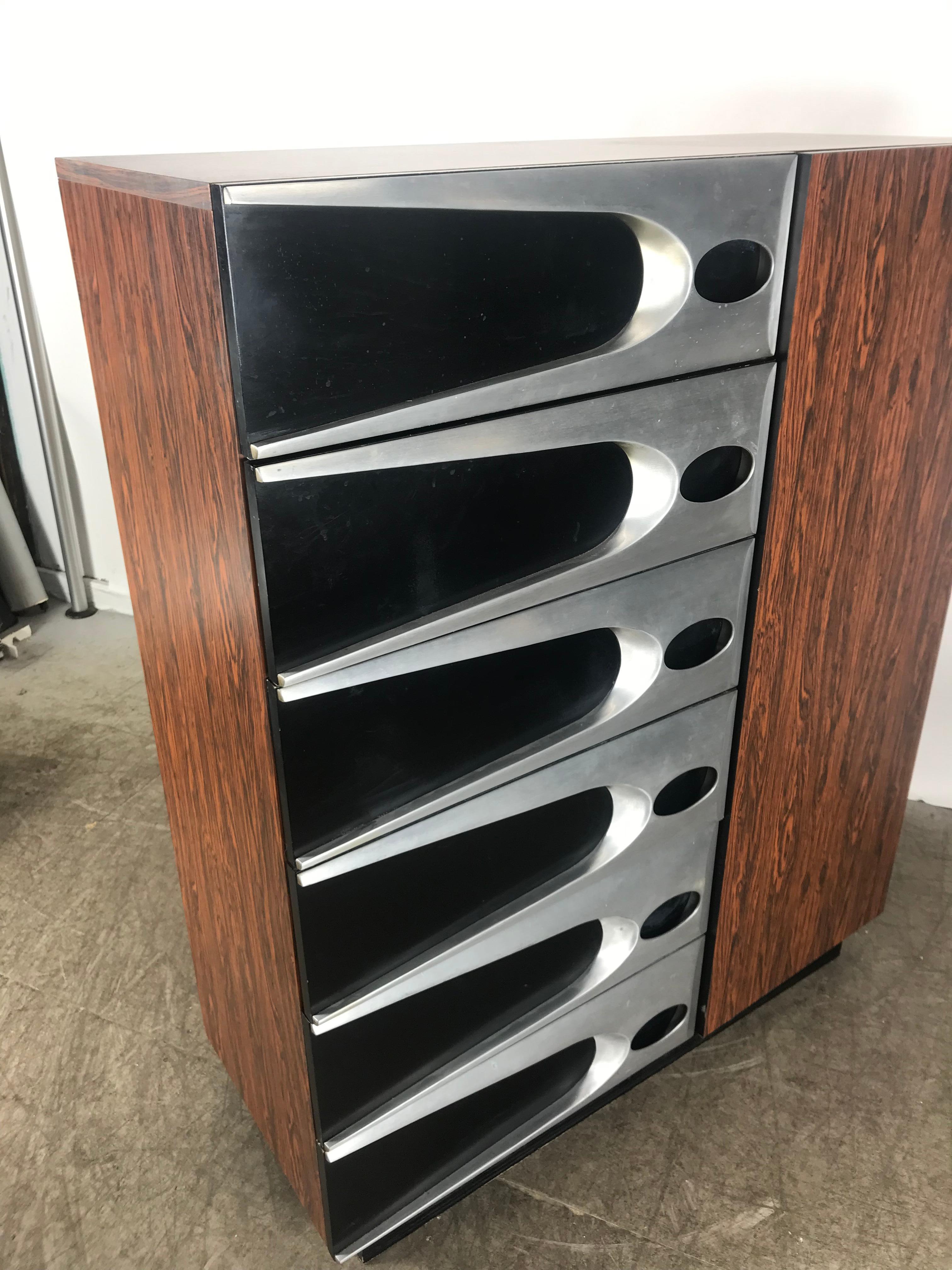 Modernist, Space Age 6-drawer dresser / armoire.. Elegance blended with Space Age design. Most unusual rosewood melamine .laminate and aluminum. Dated 1974 Six drawers on the left, large closet door with 4 shelves. Please see additional listings for