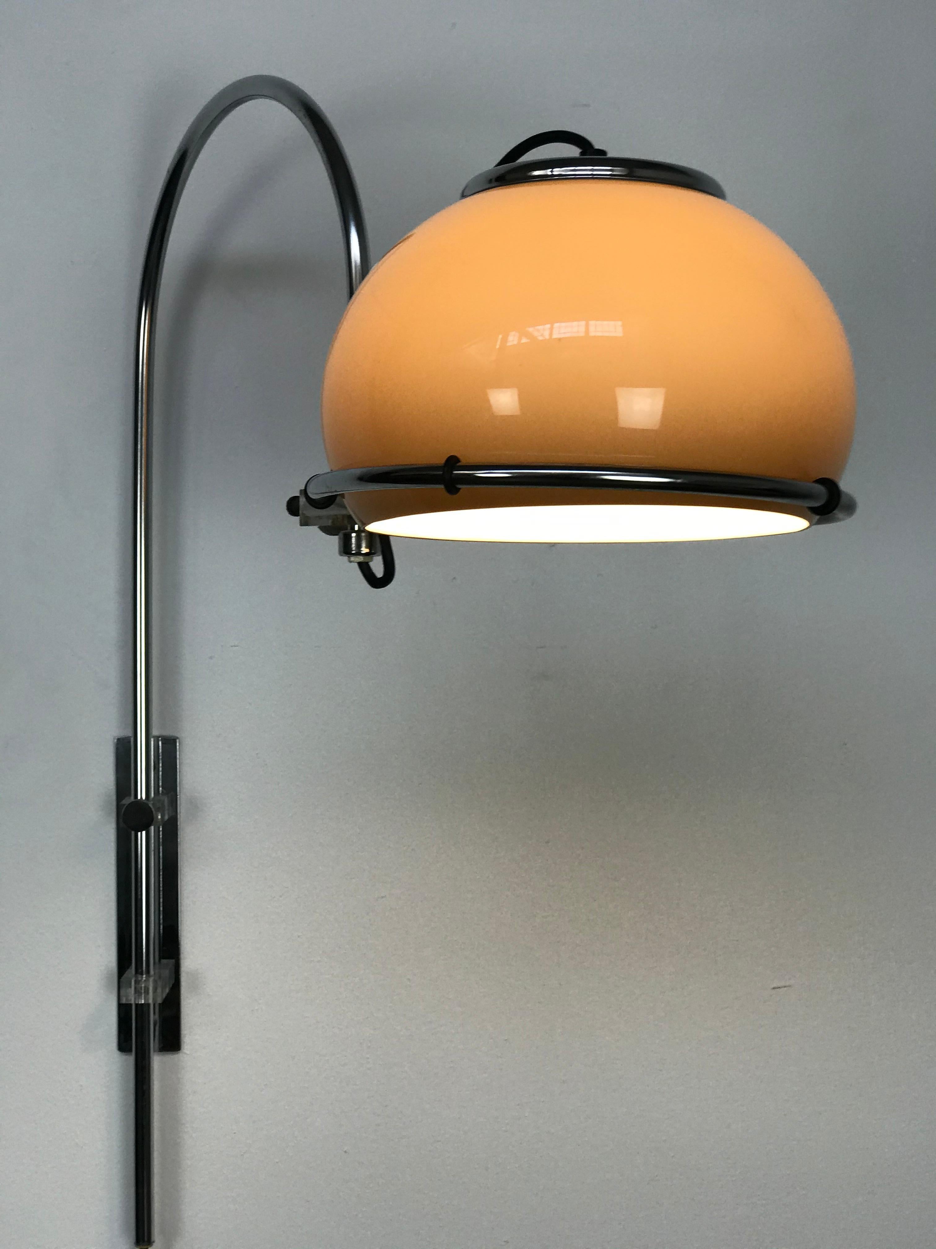 A very nice example of Dutch lighting by renowned Holland lighting company Dijkstra Lumens from the late 1960s early 1970s. The wall-mounted lamp features a 180 degree chrome and Lucite wall-mounted base and curved arm that has a hoop that allows