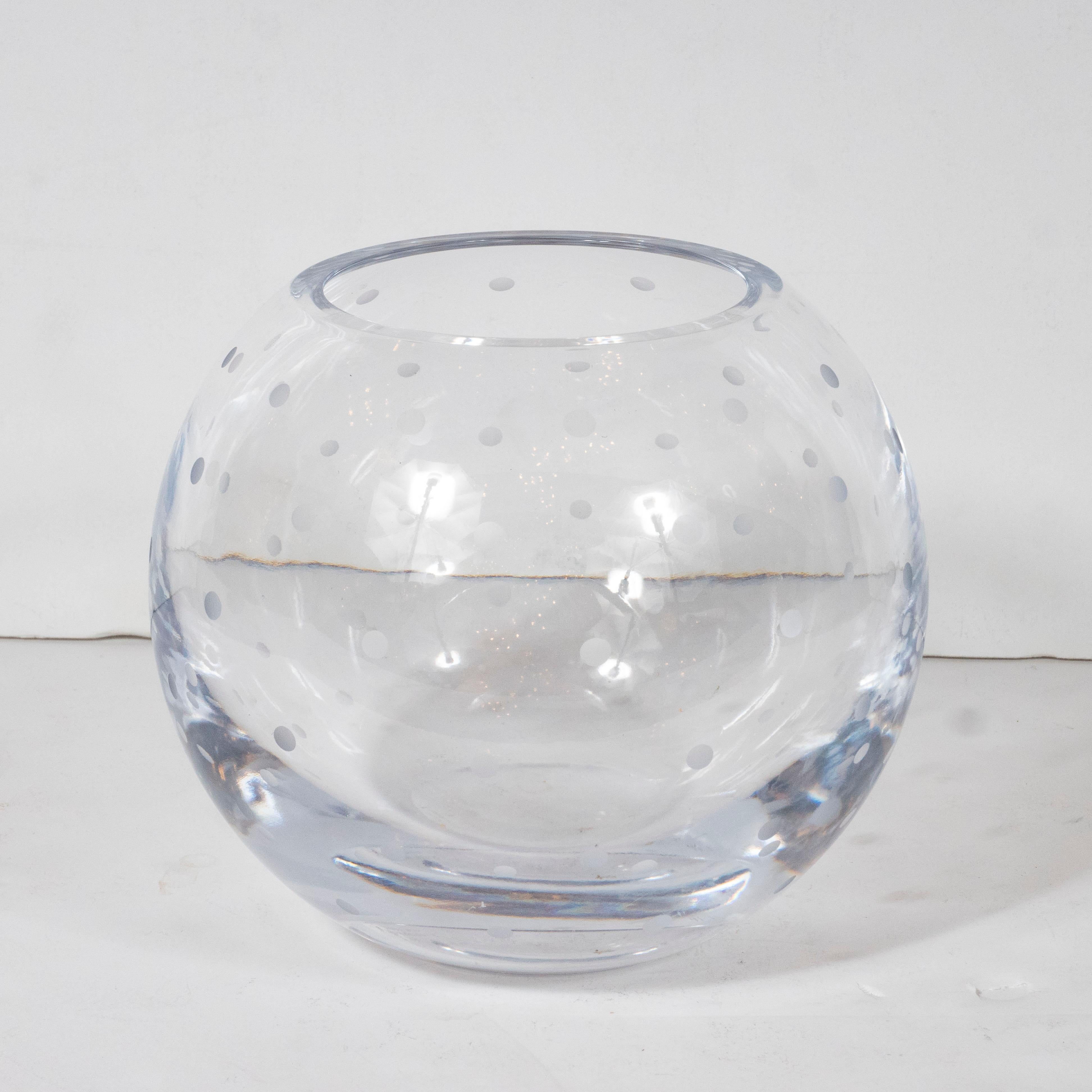 This modernist vase was realized in the United States during the 20th century. It offers a spherical form with evenly spaced frosted dots etched throughout the translucent body of the piece. With its clean modernist lines and monochromatic palate,