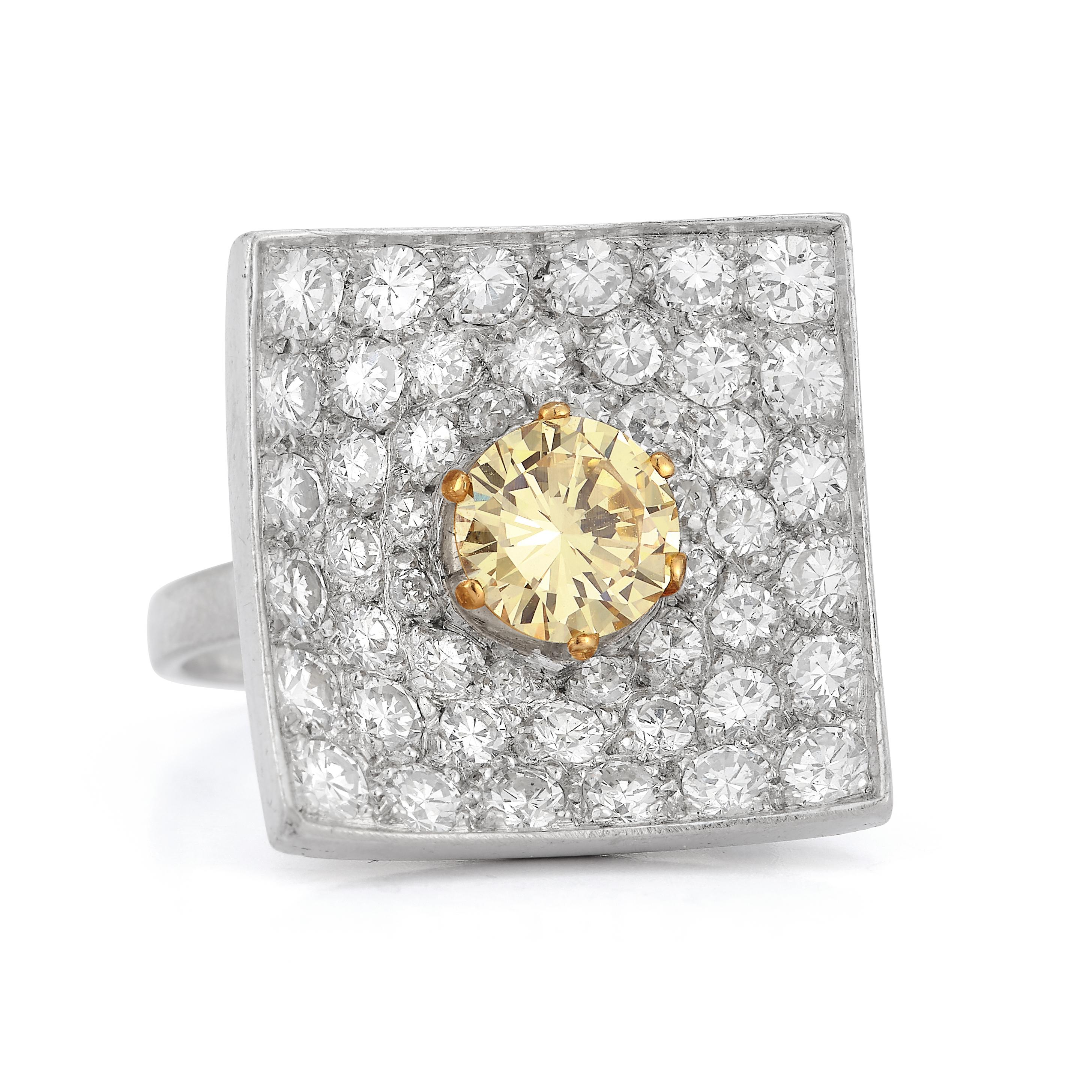 Modernist Square Shaped Yellow Diamond Ring
1 round cut yellow diamond surrounded by white pave diamonds.

Yellow Diamond Approximate Weight: 1.5ct
White Diamonds total approximate Weight:  36.0ct

Ring Size: 6.25

Resizable free of charge 

Metal