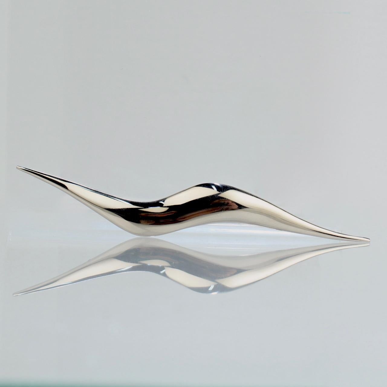 A stainless steel brooch.

By the American Modernist Jose De Rivera.

In a stylized 