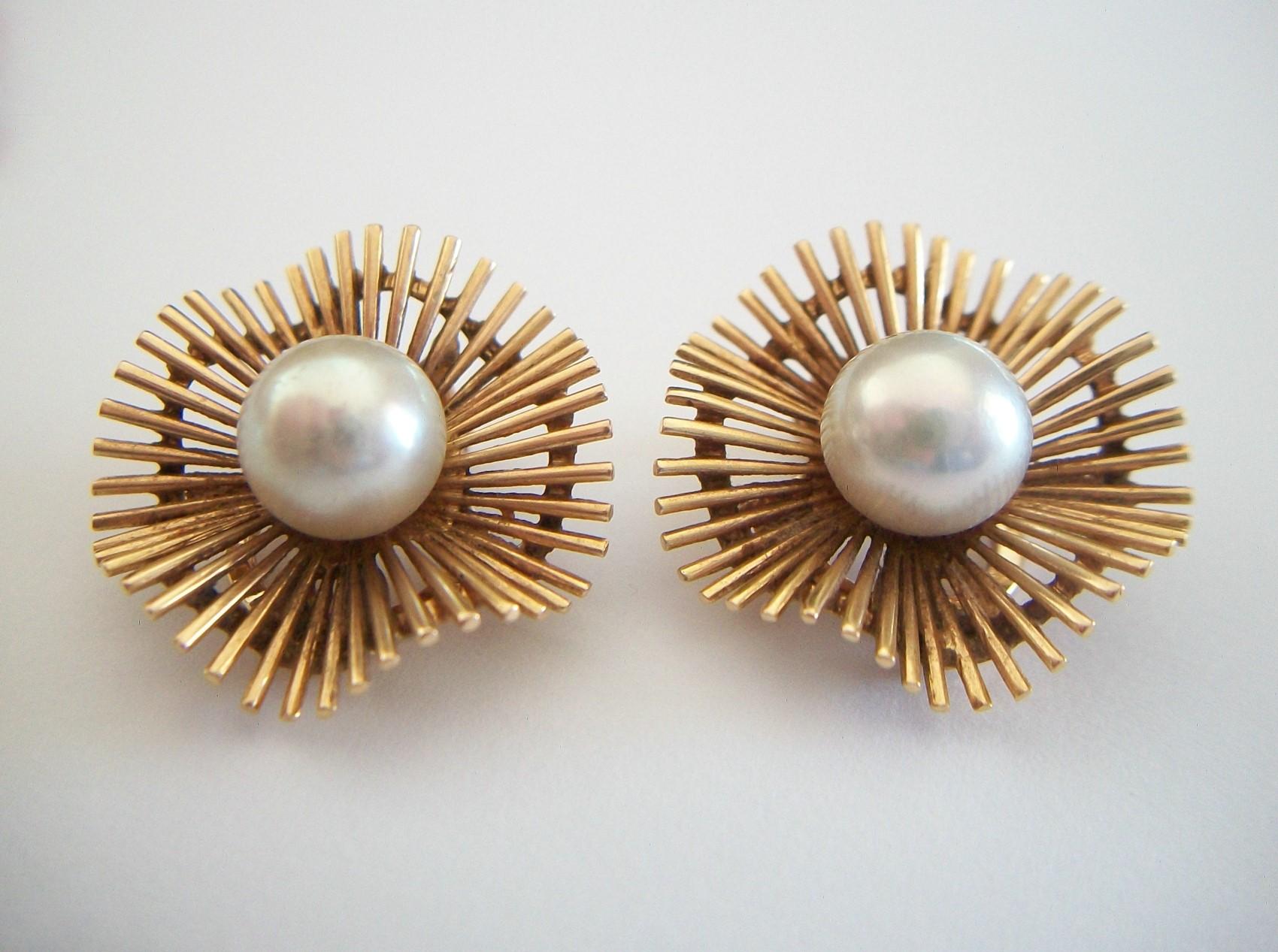 Modernist Starburst cultured pearl and 18K yellow gold ear clips - refined and elegant - fine hand made quality - each ear clip featuring a cultured pearl (approx. 8 mm. in diameter) to the center, surrounded by undulating gold bars secured in place