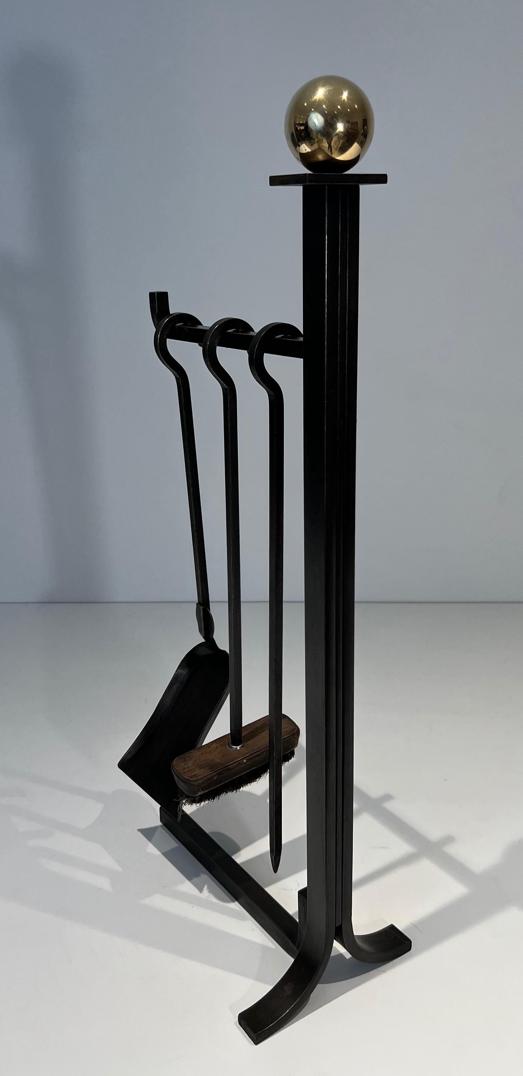 This rare modernist fireplace tools on stand is made of steel and brass. This is a French work in the Style of Jacques Adnet. Circa 1970
