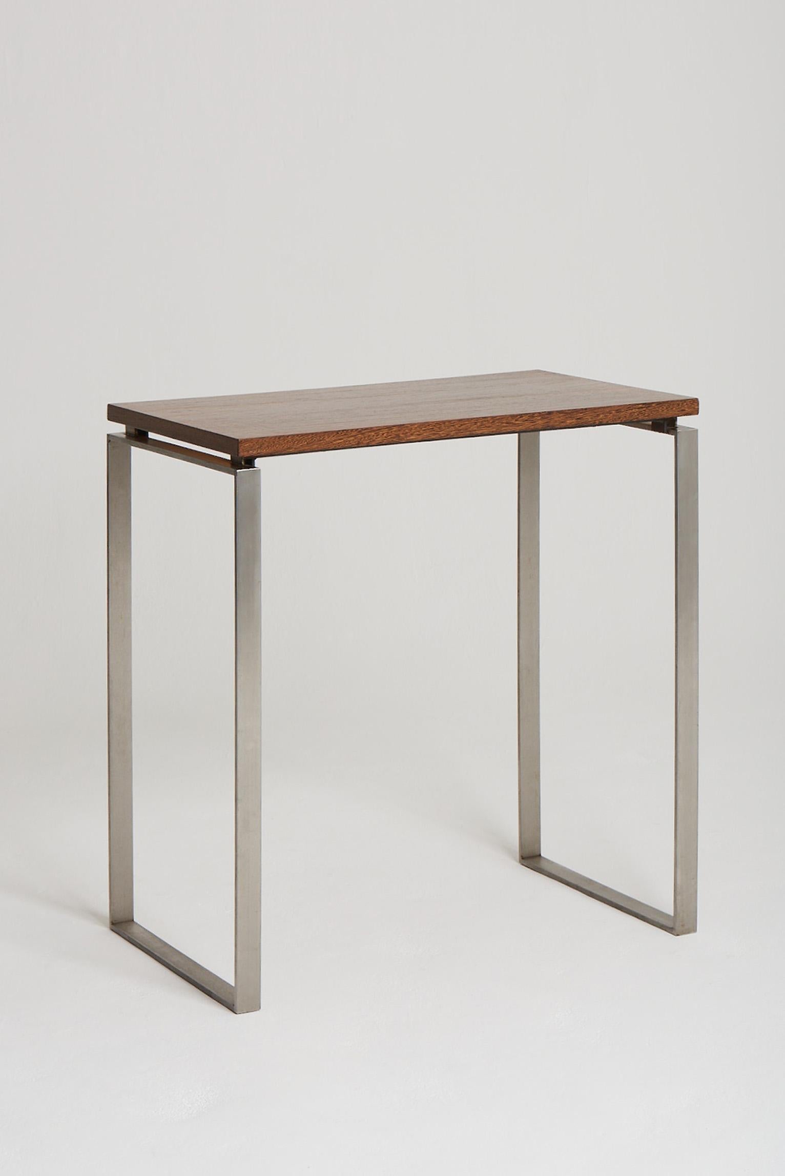 A Modernist brushed steel and palmwood top console table.
France, third quarter of the 20th century.