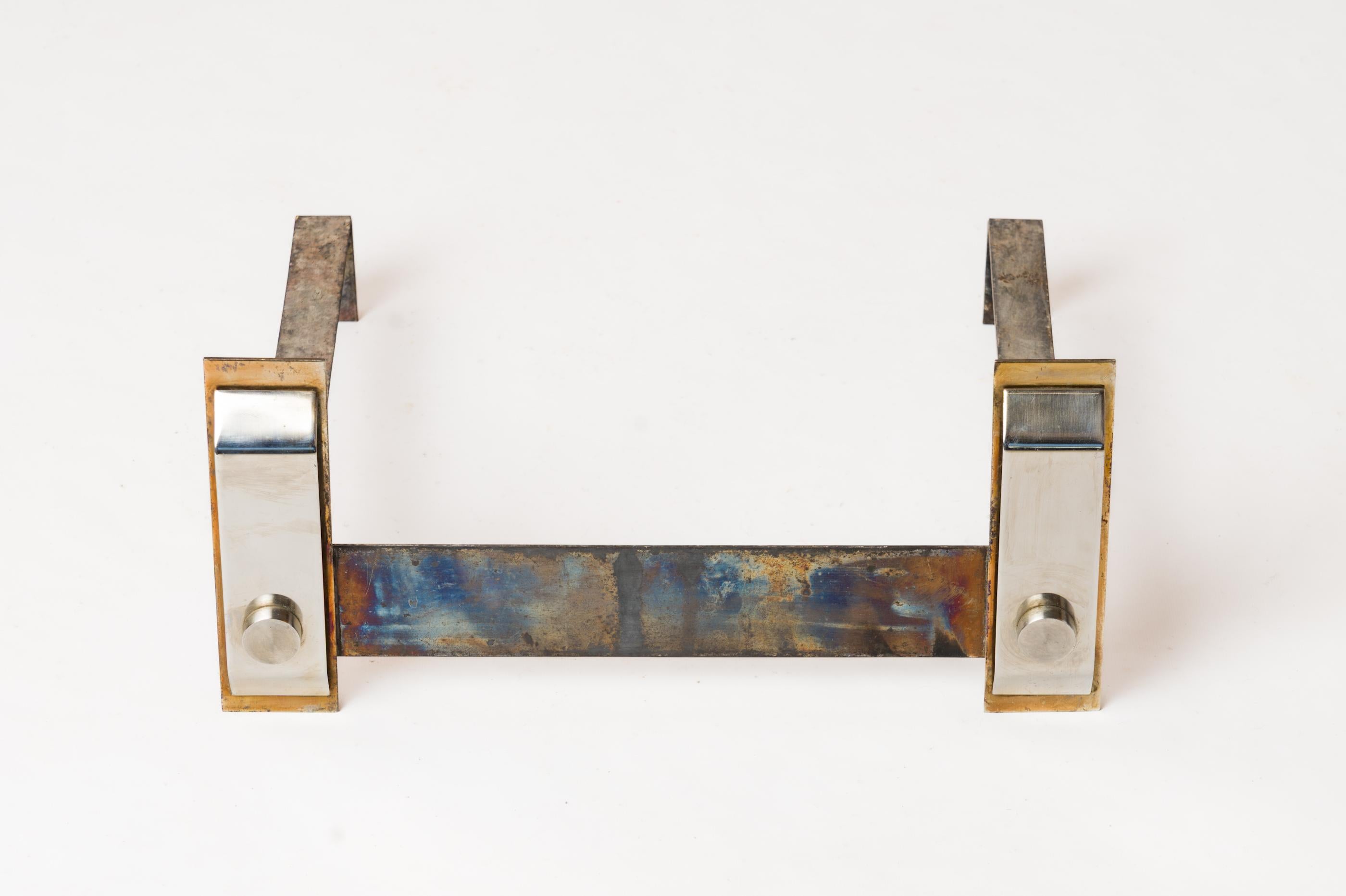 Polished steel modernist log rack with brass accents.
In fair vintage condition. 
This log rack will ship from France and can be returned to either France or to an upstate NY facility. Price includes shipping to the US except for possible customs