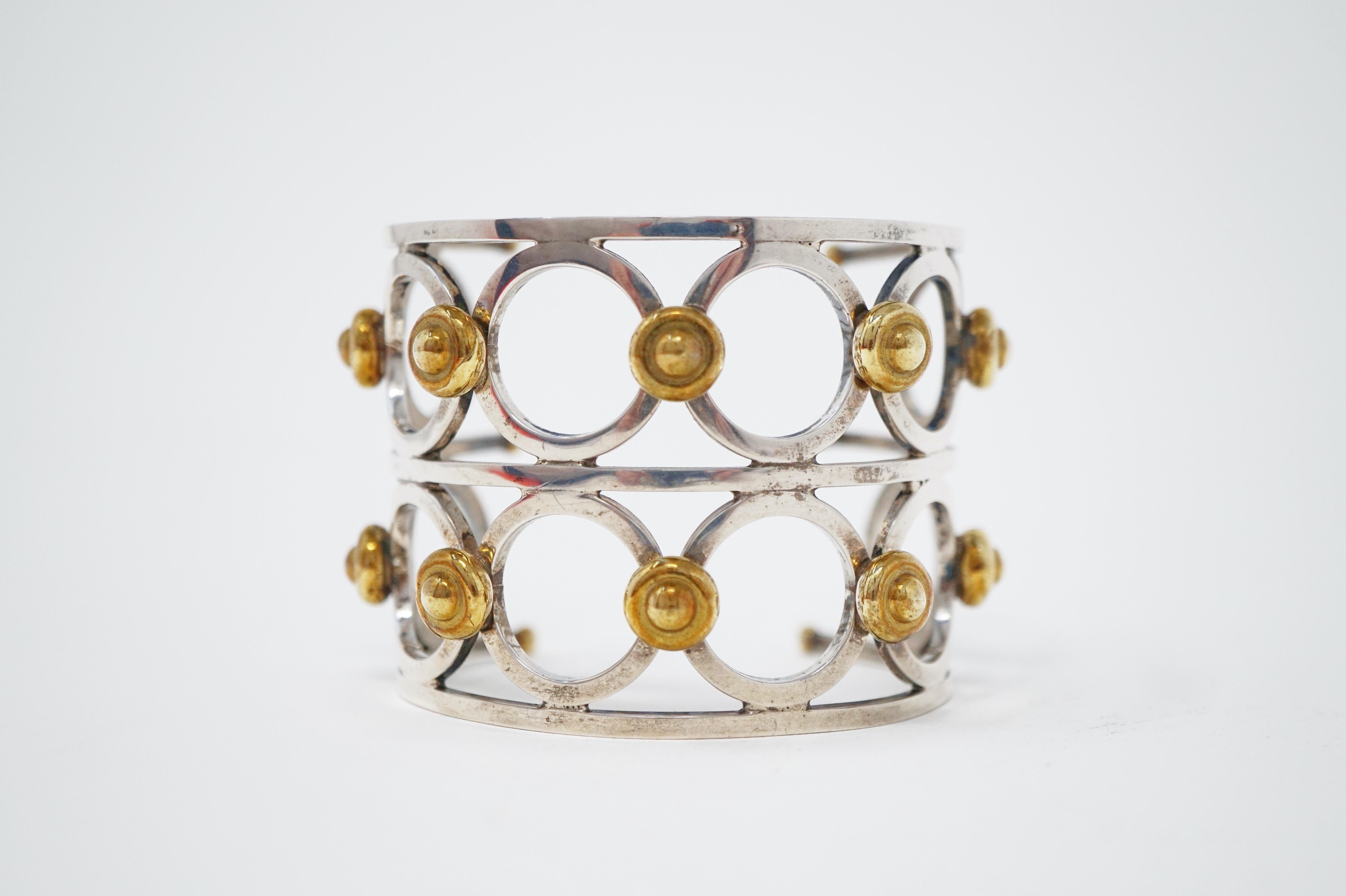 Make a bold statement with this chic steel modernist cuff bracelet with gold-plated details, circa 1970s.  Shiny, polished steel hardware with just the right amount of patina makes this piece a real stunner!  A timeless addition to your vintage