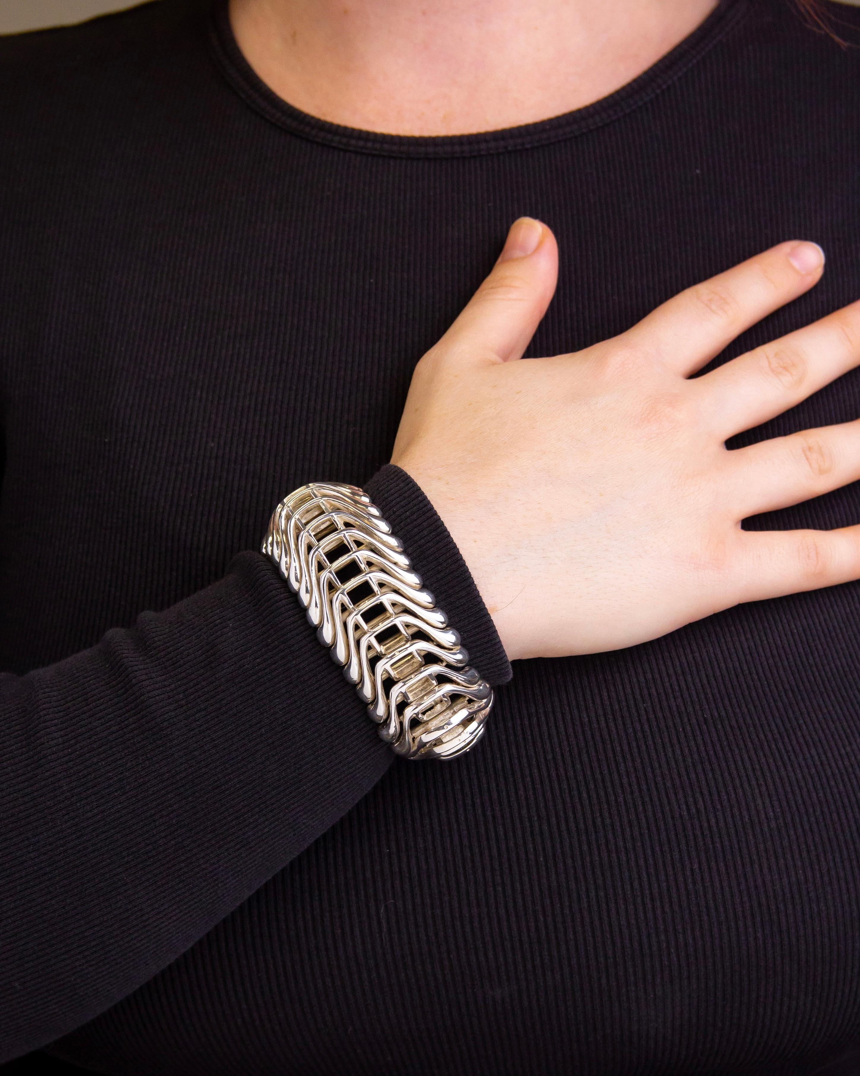 Crafted during the mid 20th century this bracelet is reminiscent of the designs produced by Scandinavian silversmiths in the 1960s and 1970s. The unmarked bracelet has been tested as sterling silver, is articulated, and terminates with a tongue and