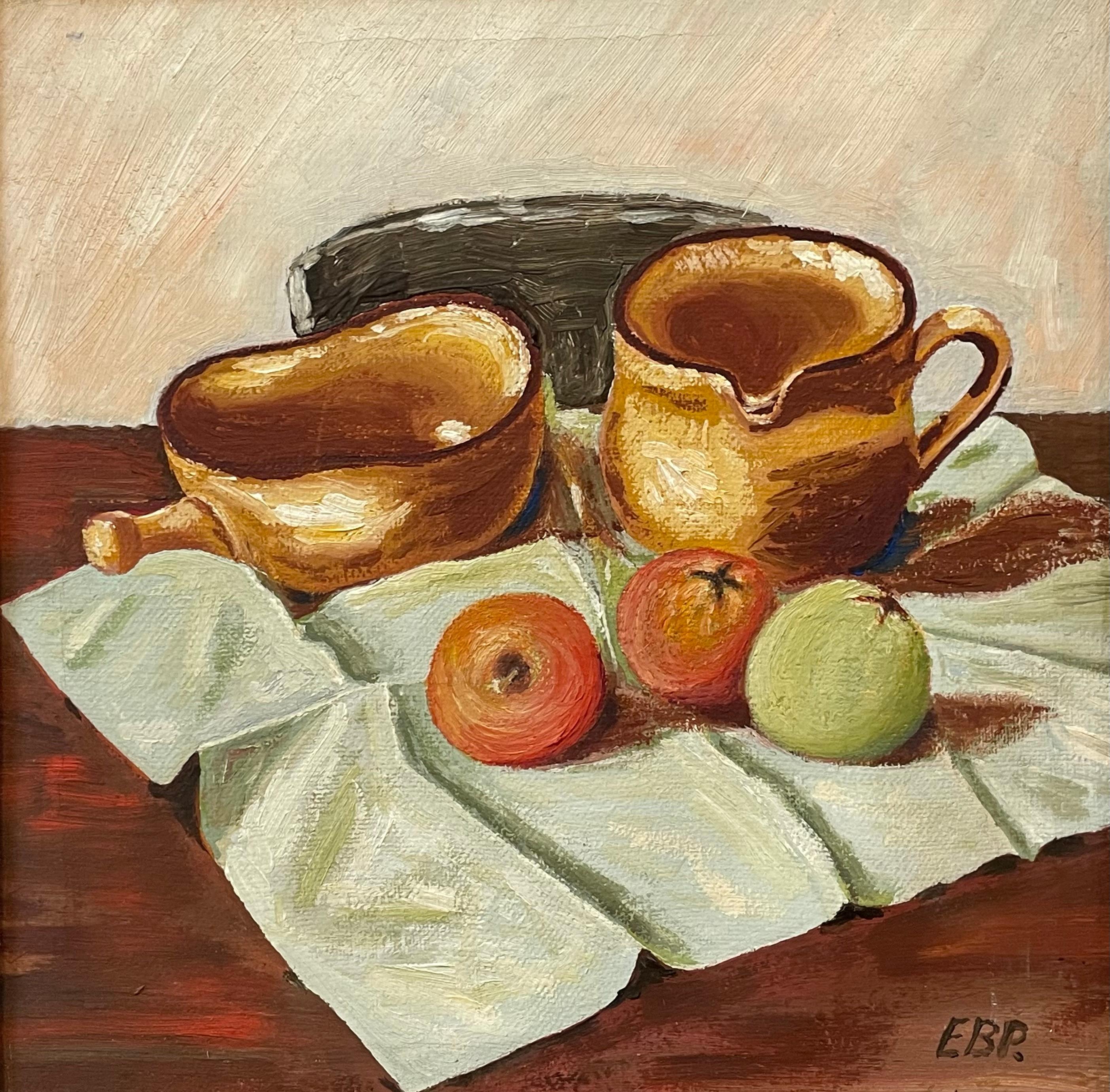 A mid-century modern still life painting depicting two ochre ceramic pitchers and three apples arranged on a softly draped cloth. The artist, signed EBR, captures the warmth and quiet beauty of everyday objects with remarkable sensitivity. Rendered