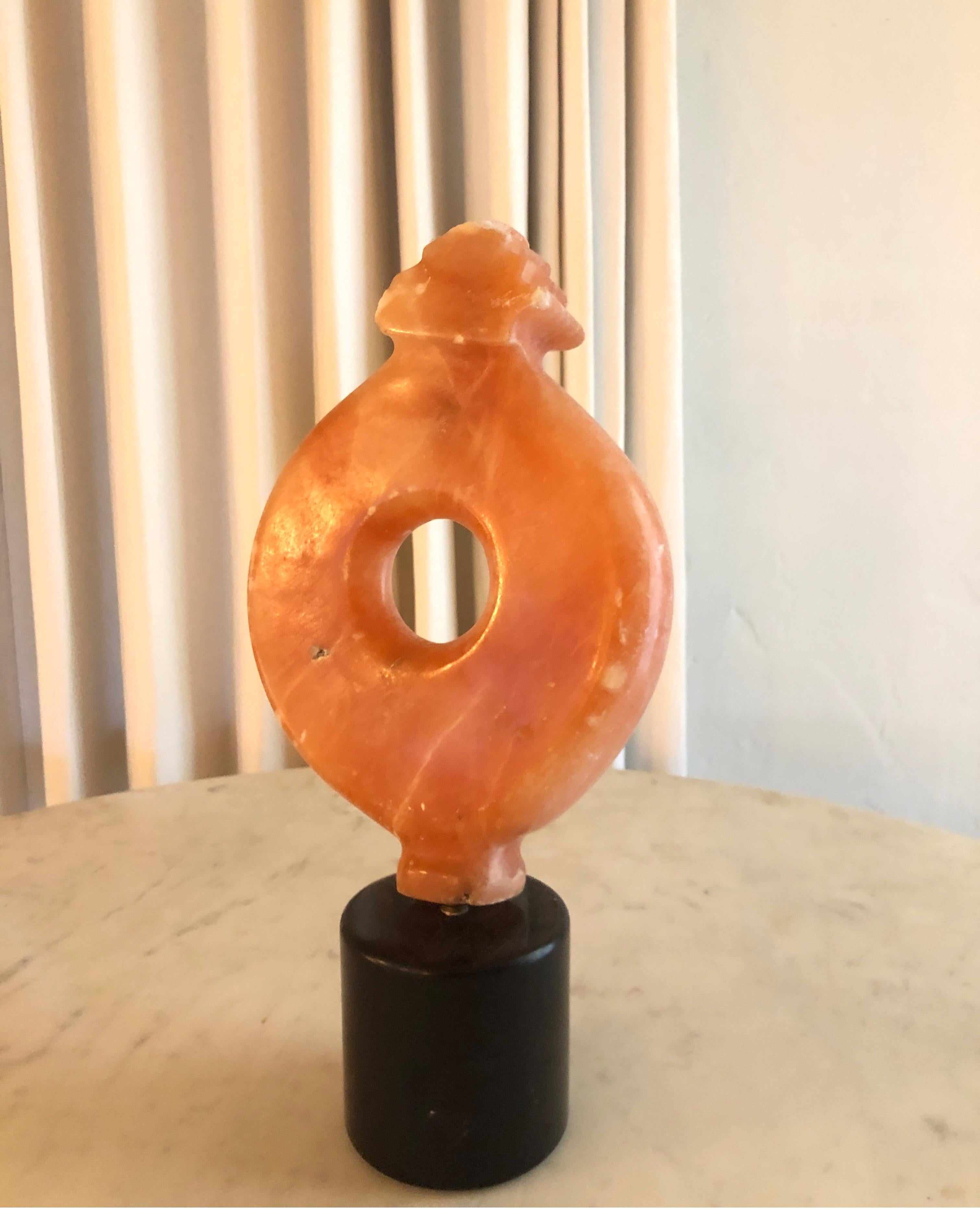 Modernist orange stone sculpture mounted on black marble.
Signed in infamous hearts by Yehuda 