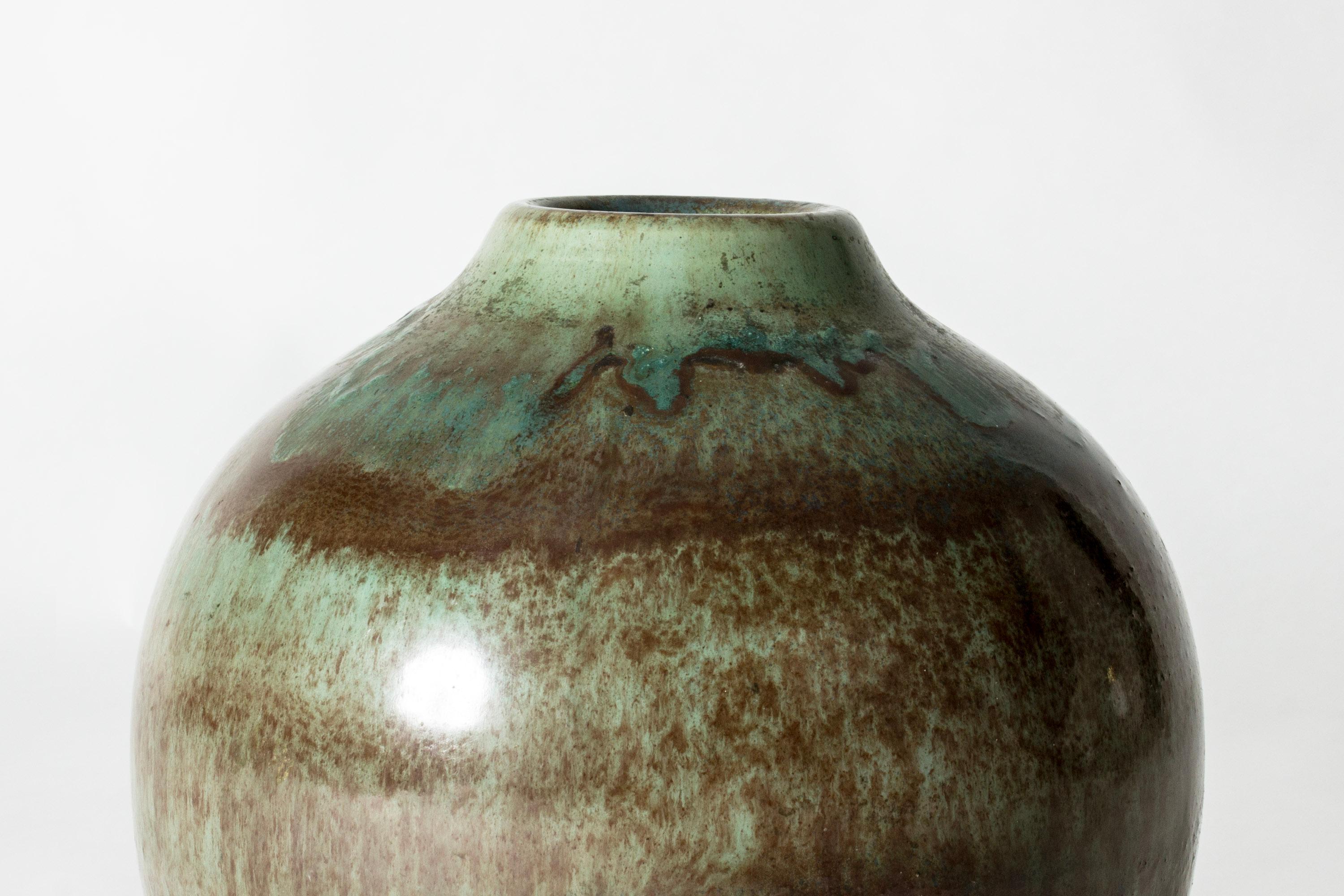 Stoneware floor vase by Gertrud Lönegren. Beautiful, subdued tones of ocean green and brown in runny, diluted strokes around the body.
