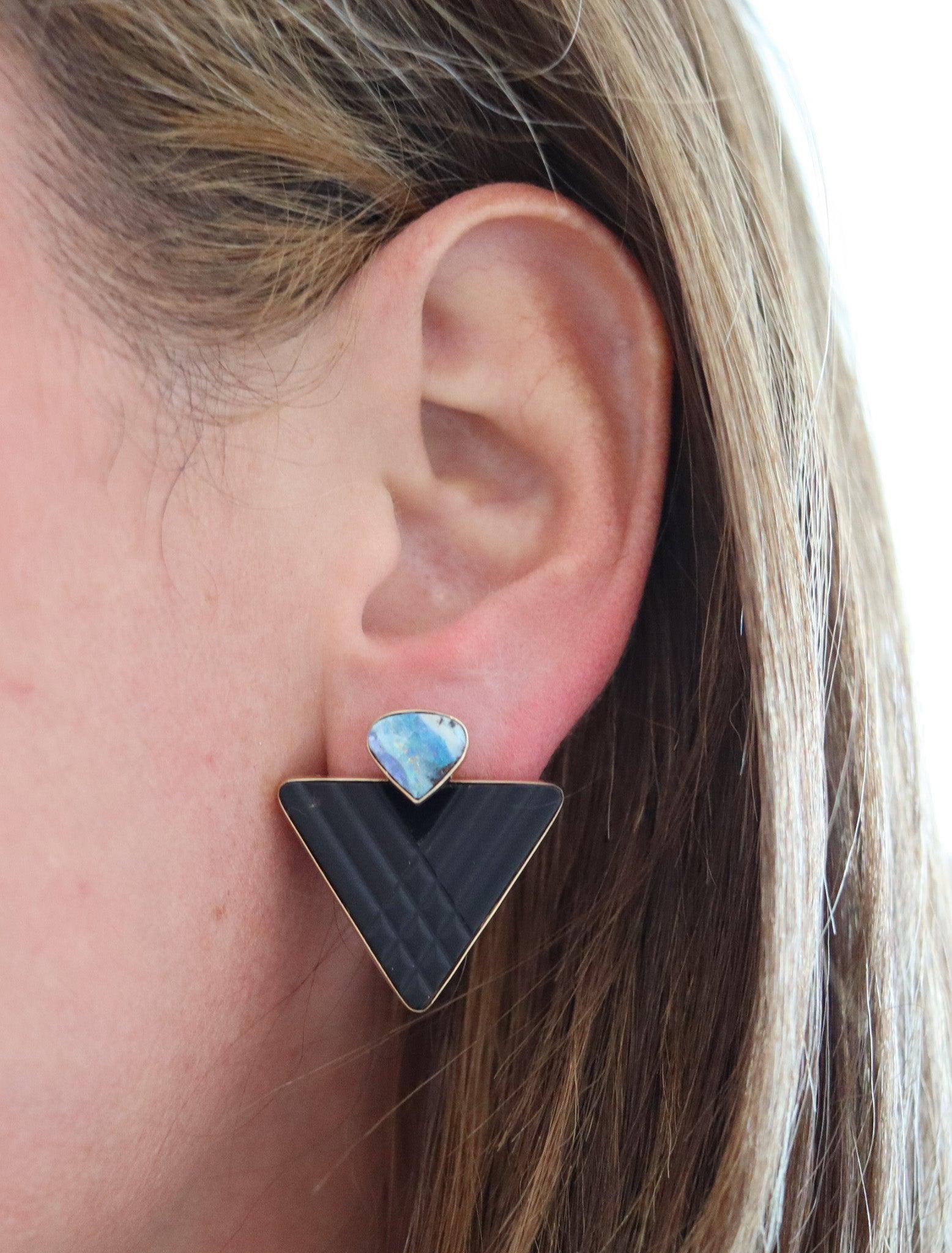 Modernist earrings with boulder opals and black jet.

This beautiful pair of modernist studs earrings, was crafted in Australia with geometric triangular shapes in solid yellow gold of 14Kt with high polished finish. They are mounted with a gorgeous