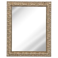 Miroir rectangulaire moderniste stylisé en bois doré sculpté et feuillagé