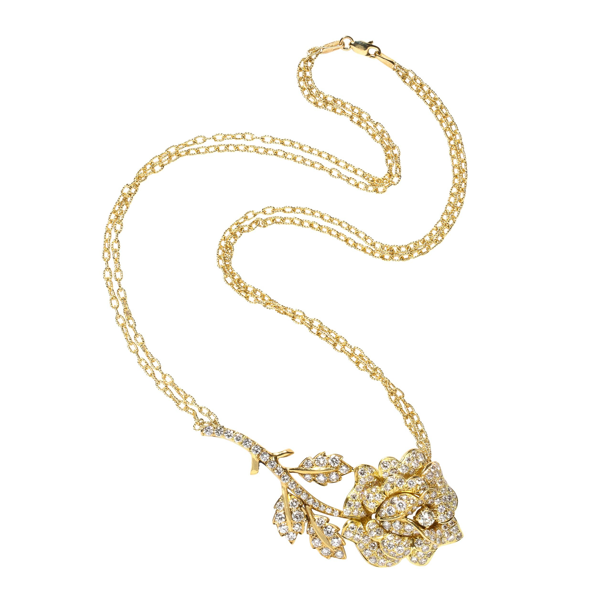 This stunning modernist necklace was realized in Italy during the latter half of the 20th century. It offers a stylized rose complete with a blooming flower, bifurcated leaves and thorns in 18kt yellow gold and diamonds. The pendant is flooded with