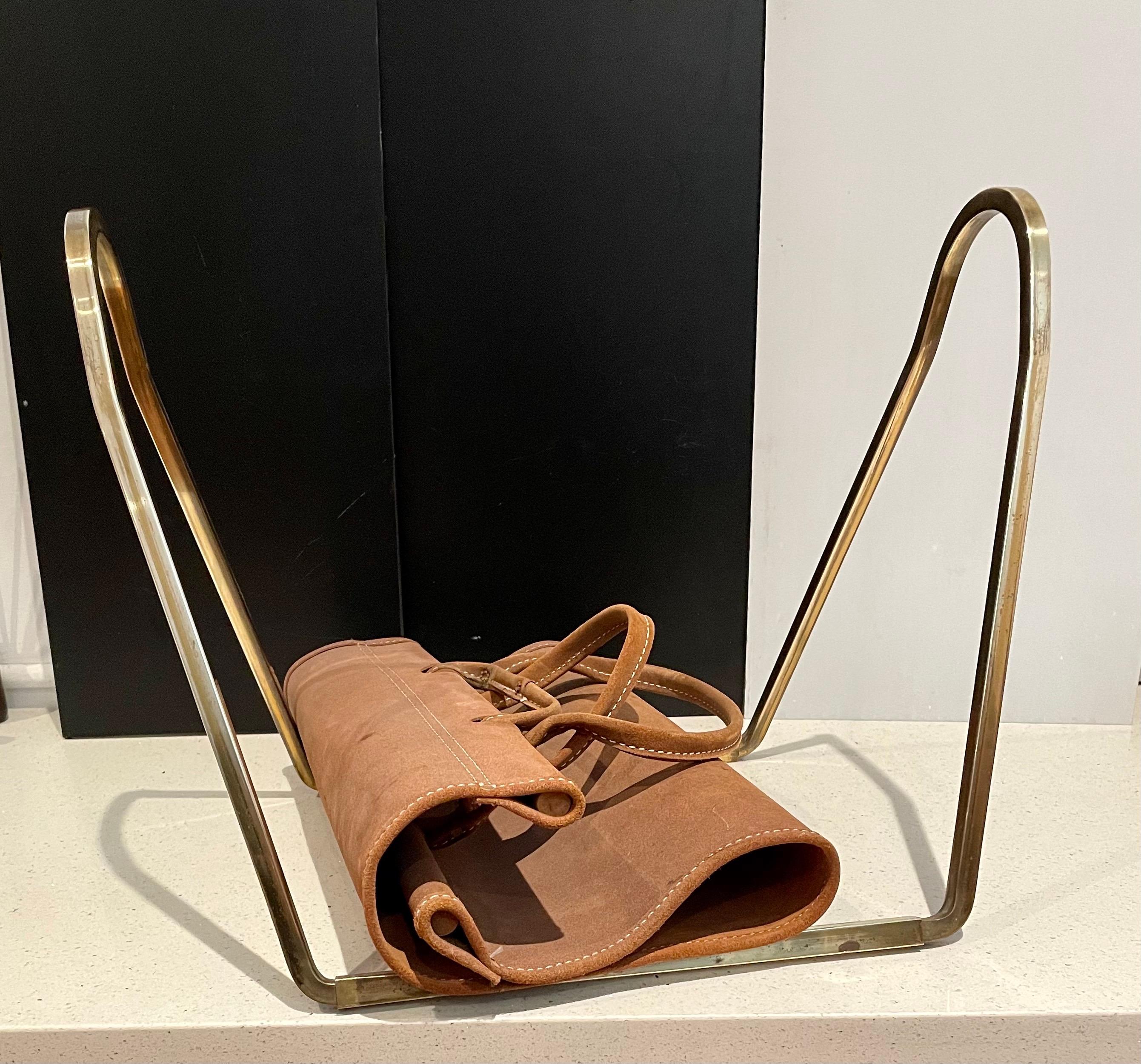 Midcentury solid brass and suede log holder, magazine rack, circa 1970s great simple design the base comes apart, in 4 parts we polished a little but left some patina the leather part its stitched on the edge shows some wear due to age has handles