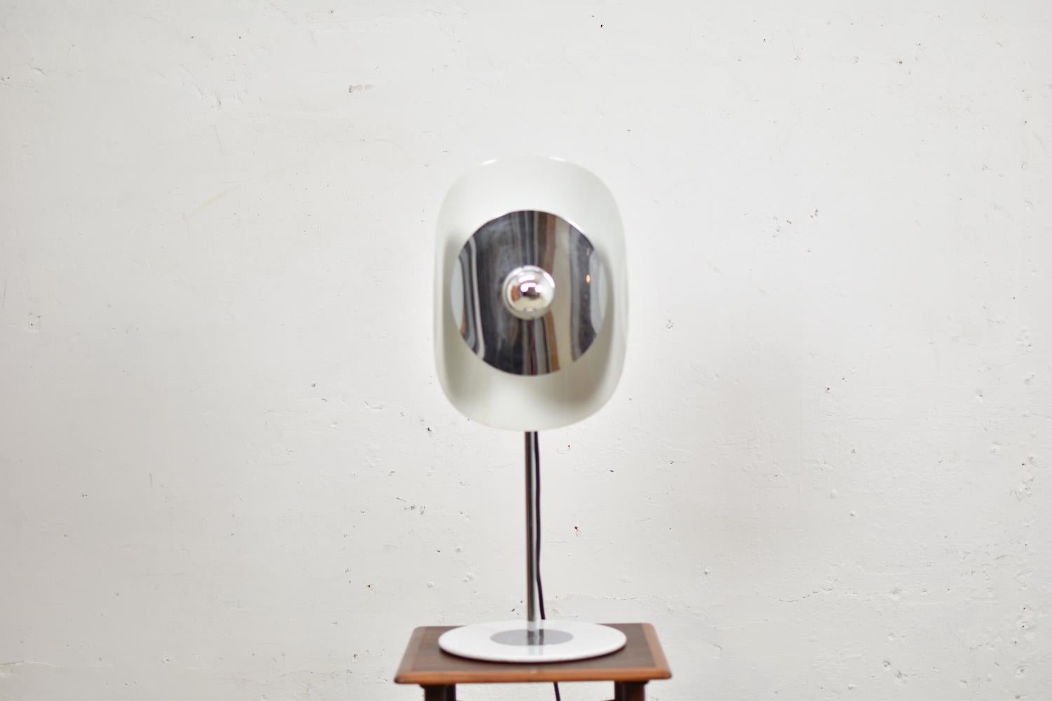 Rare table lamp by Brevetatto, Italy, 1970s. This Modernist desk lamp is made out of chromed metal and white lacquered aluminium. Adjustable in height. Labeled.