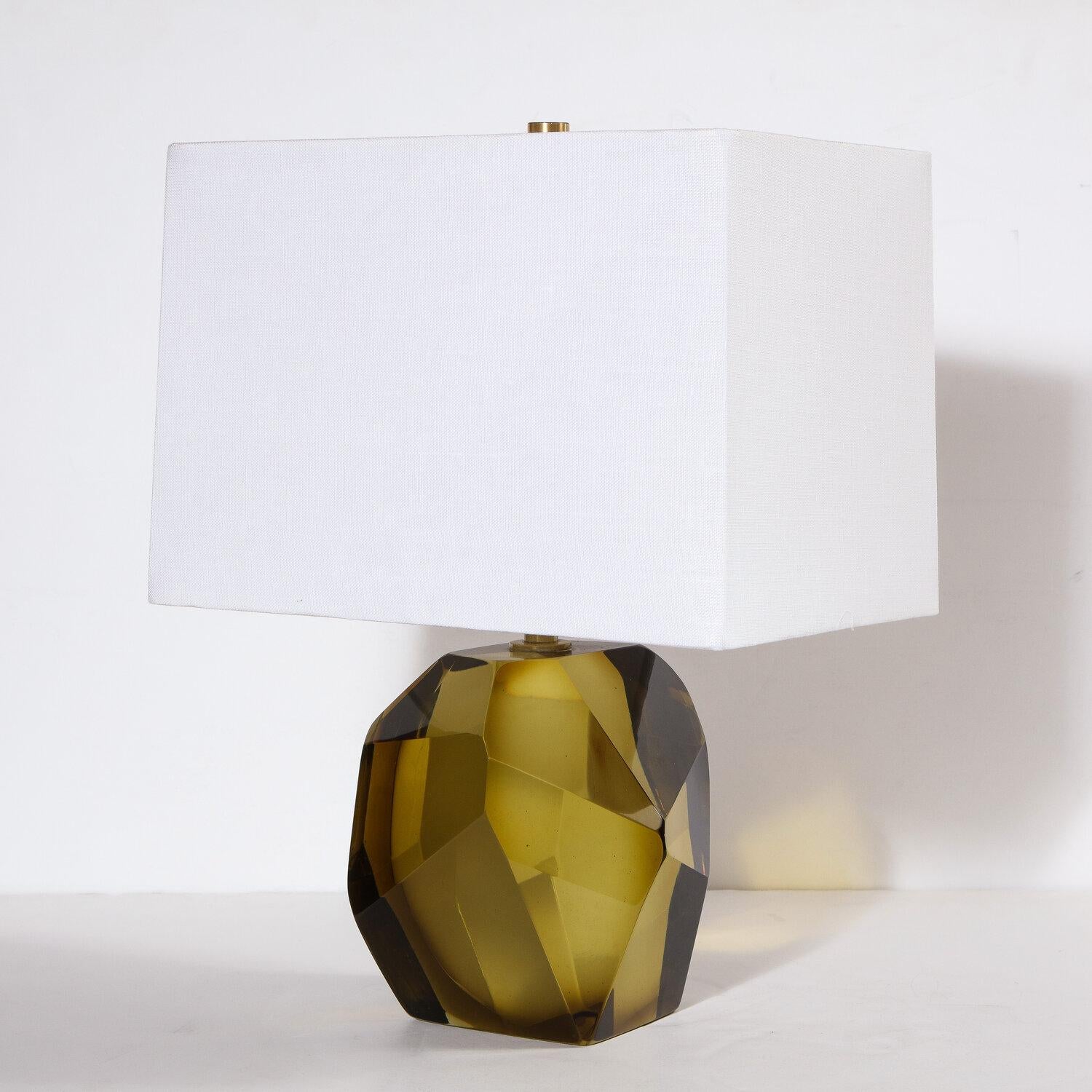 This stunning and elegant pair of table lamps were realized in Murano, Italy- the island off the coast of Venice renowned for centuries for its superlative glass production. They feature faceted bodies- like oversized cut gemstones- in a gorgeous