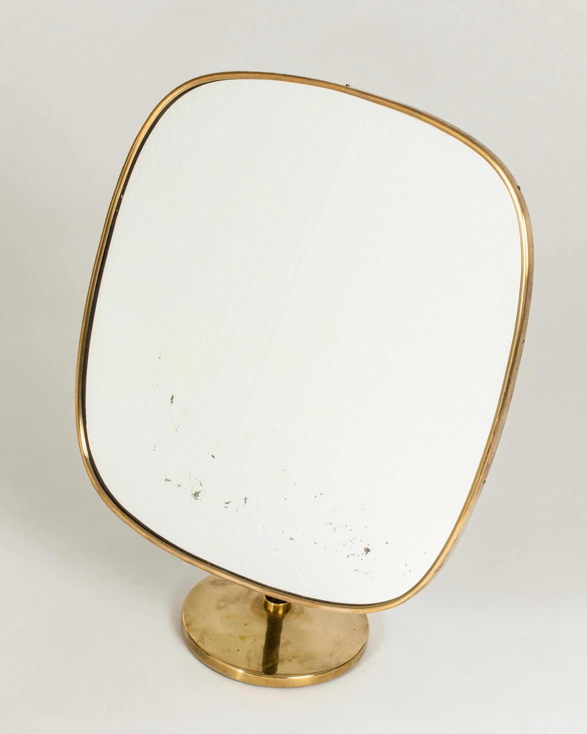 Elegant table mirror by David Rosén, part of the “Futura” series from NK. Large rectangular mirror with rounded corners and handle wound with black leather. Adjustable height and angle. Wear on the lower part of the glass.