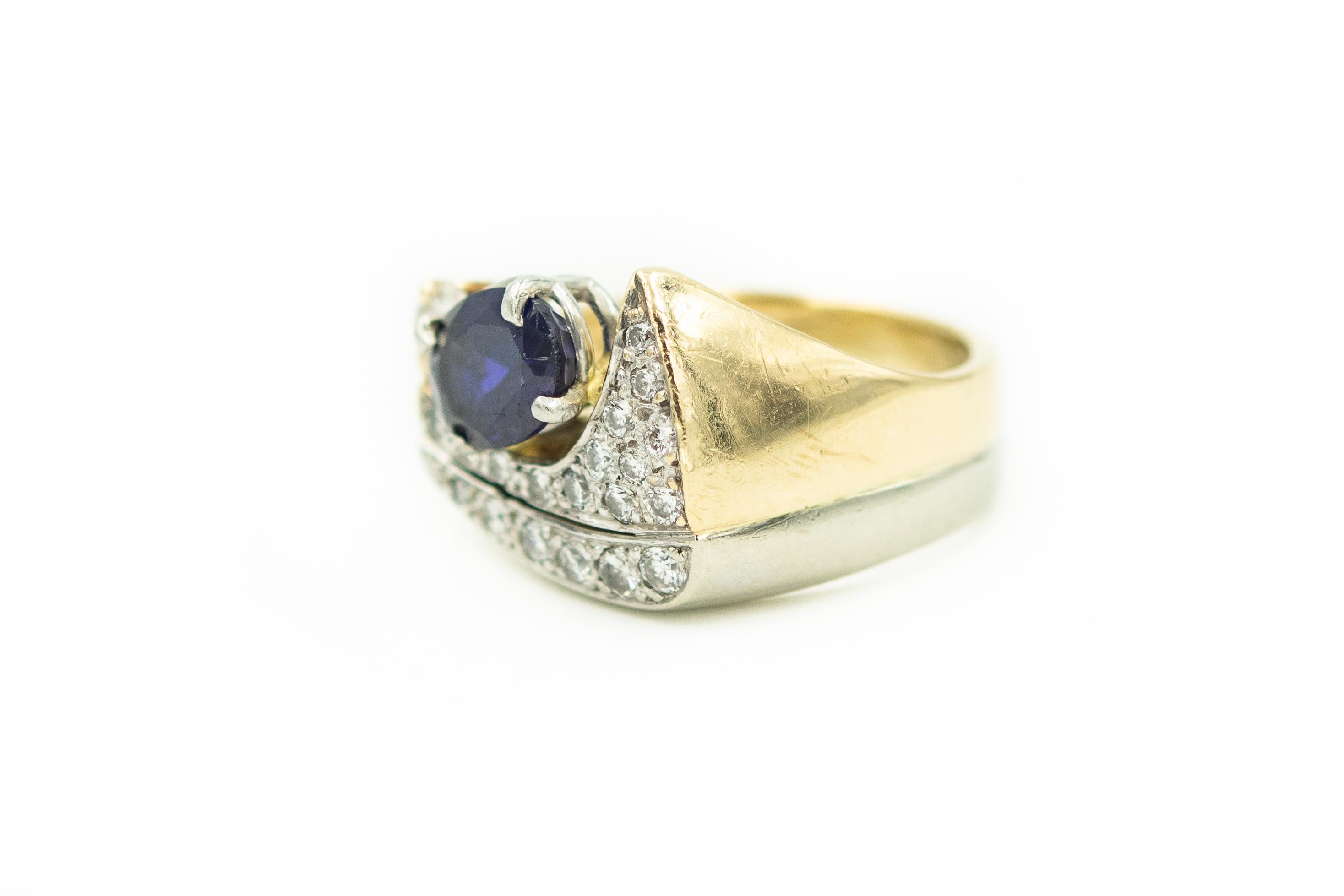 Very cool modernist stylized ring featuring a prong set oval tanzanite  (approximately 1.65 carats) which is accented by a single .15 carat (approximate weight) carat round full cut diamond and an additional 19 bead set diamonds.  The approximate