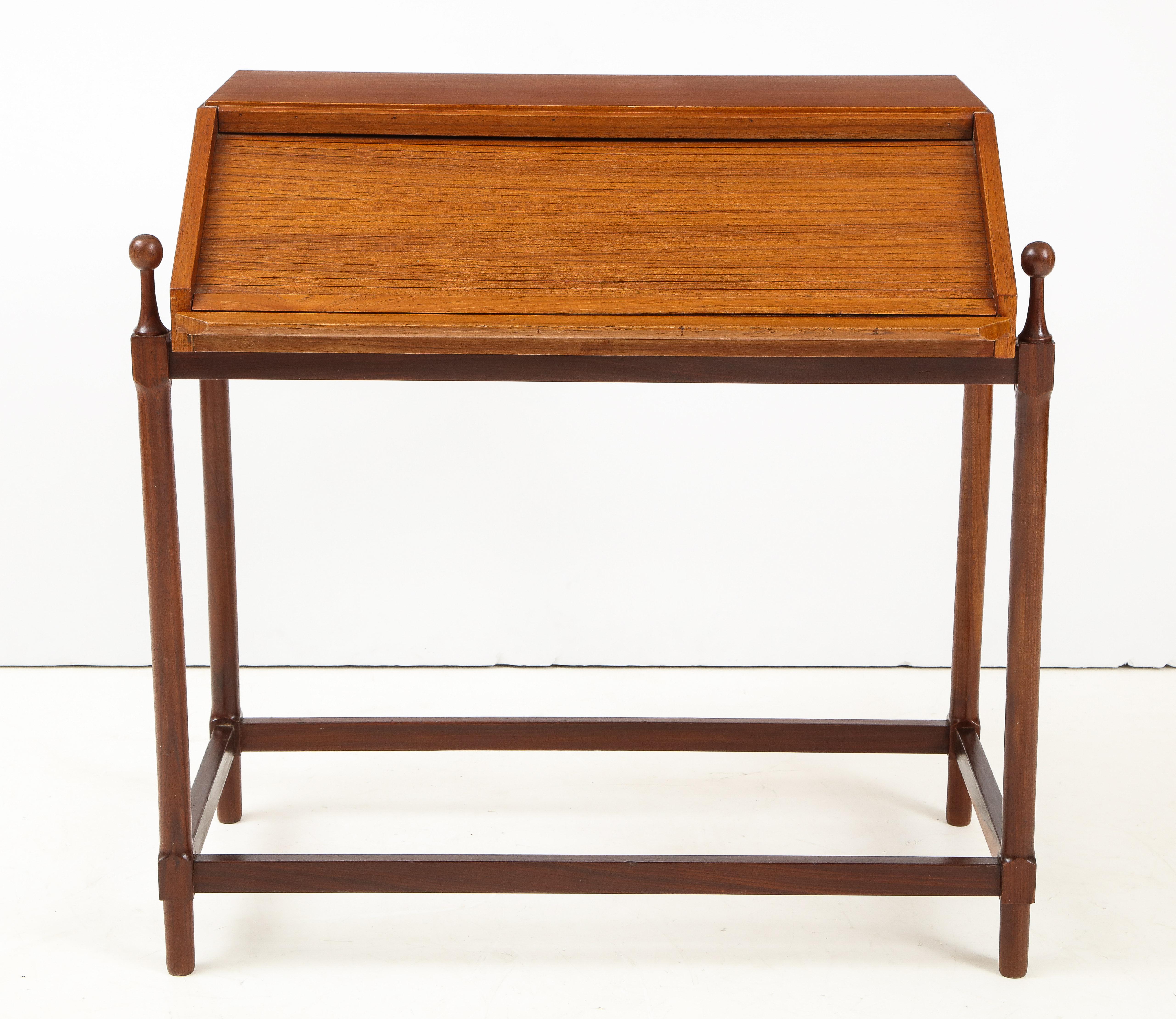 Modernist Italian 1960s teak compact rollup secretary desk by Fratelli Proserpio. Writing surface pulls out for ease of use, two trays inside the top. Very good vintage condition, unique mechanism that opens as you pullout the writing surface.