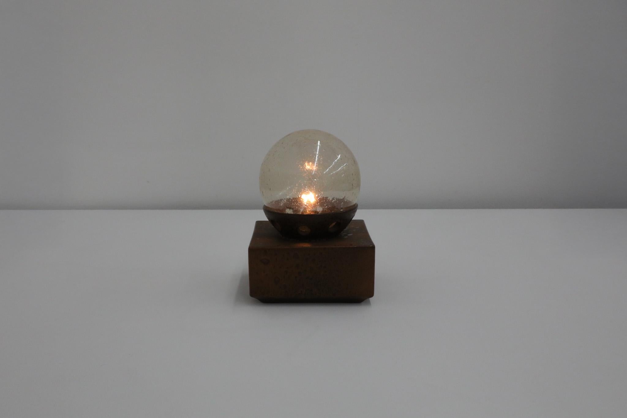 Special flecked sepia matte glazed ceramic cube lamp with amber blown glass globe. This attractive light is versatile and can be used as a wall or ceiling sconce as well as a table lamp. In original condition with visible wear and chipping