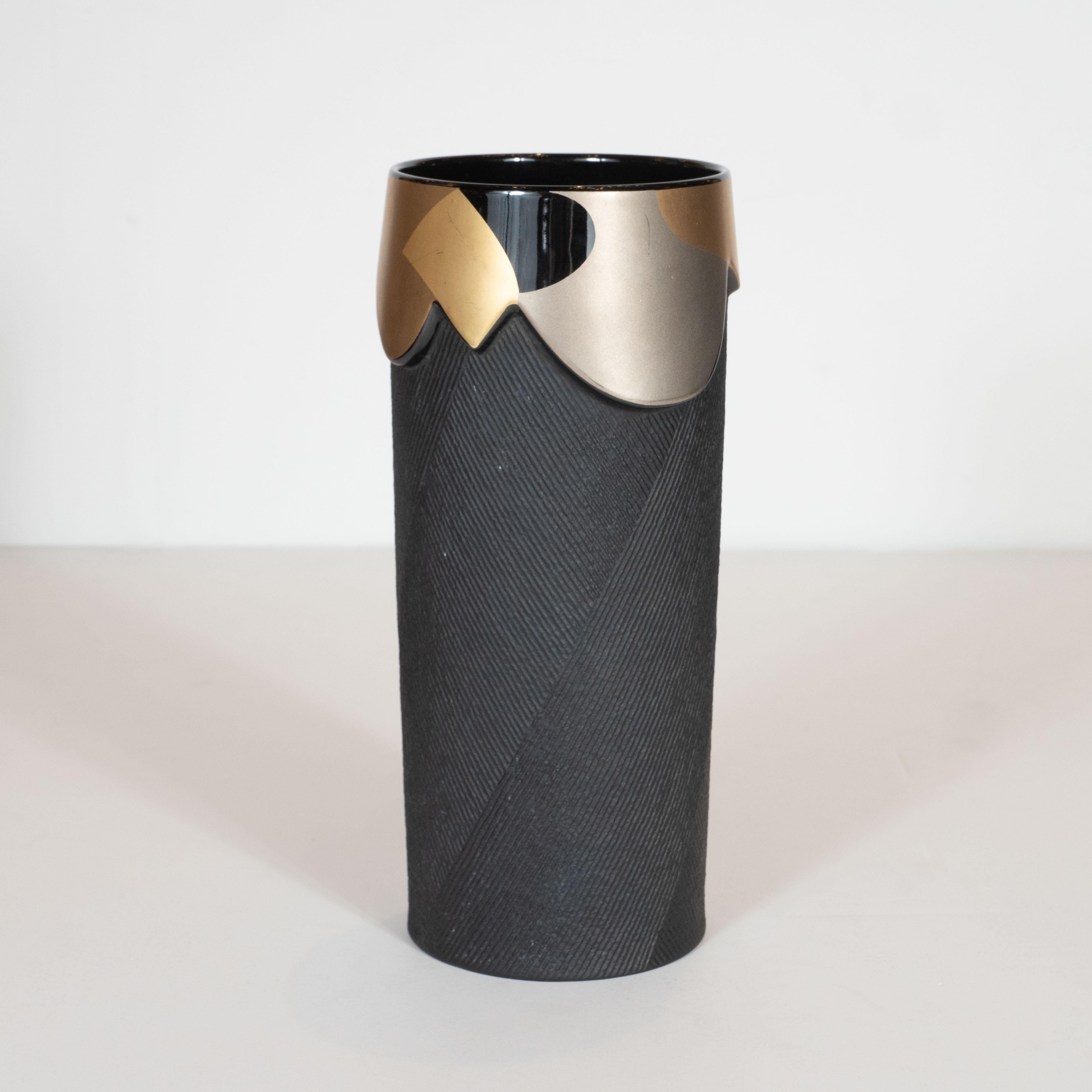 This sophisticated modernist porcelain vase was designed by Johan Van Loon handcrafted by the esteemed maker Rosenthal in Germany circa 1980. It features a cylindrical body with raised striated projections traveling in different directions that