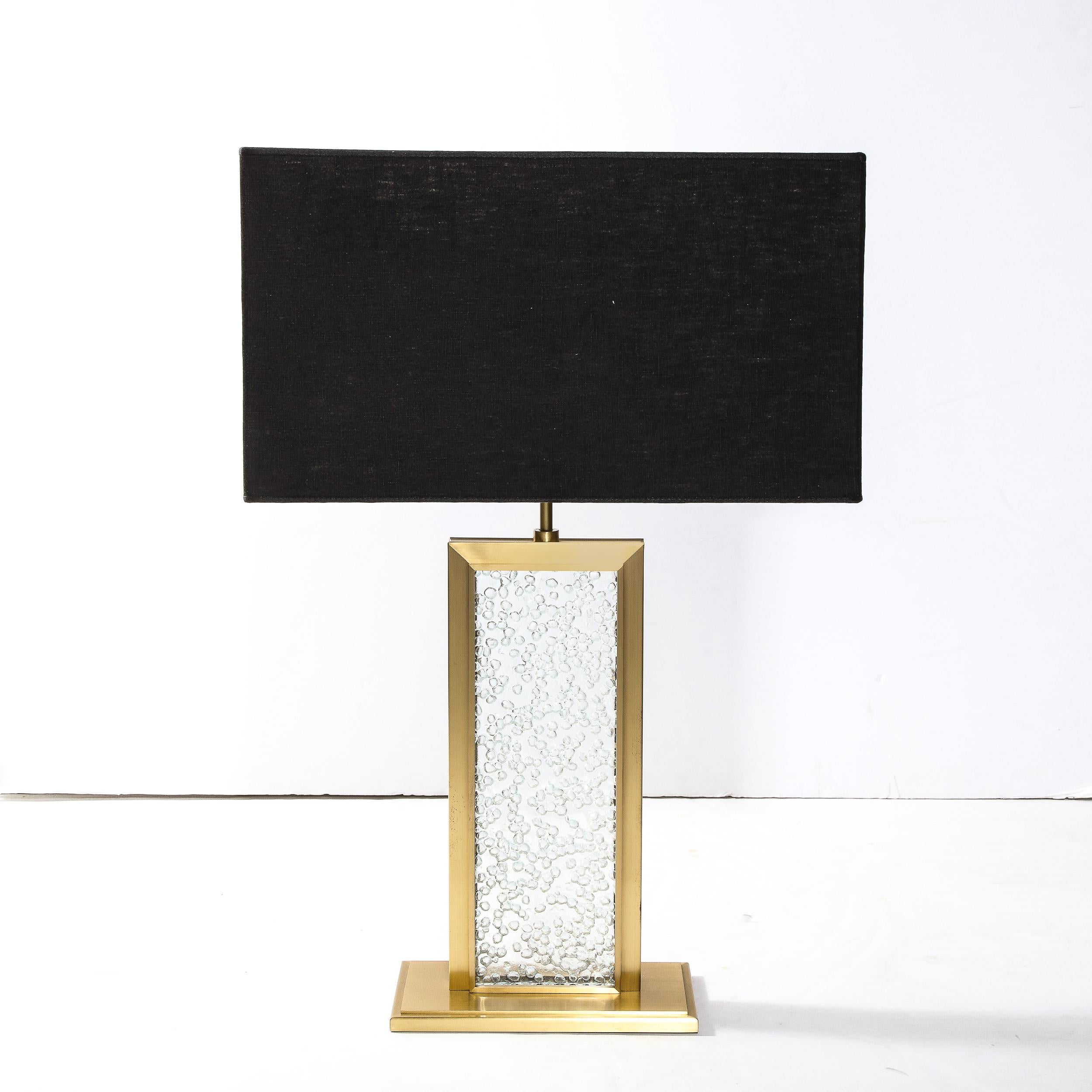 This stunning and dramatic modernist table lamp was realized in Murano, Italy- the island off the coast of Venice renowned for centuries for its superlative glass production- during the latter half of the 20th century. It features a rectangular base