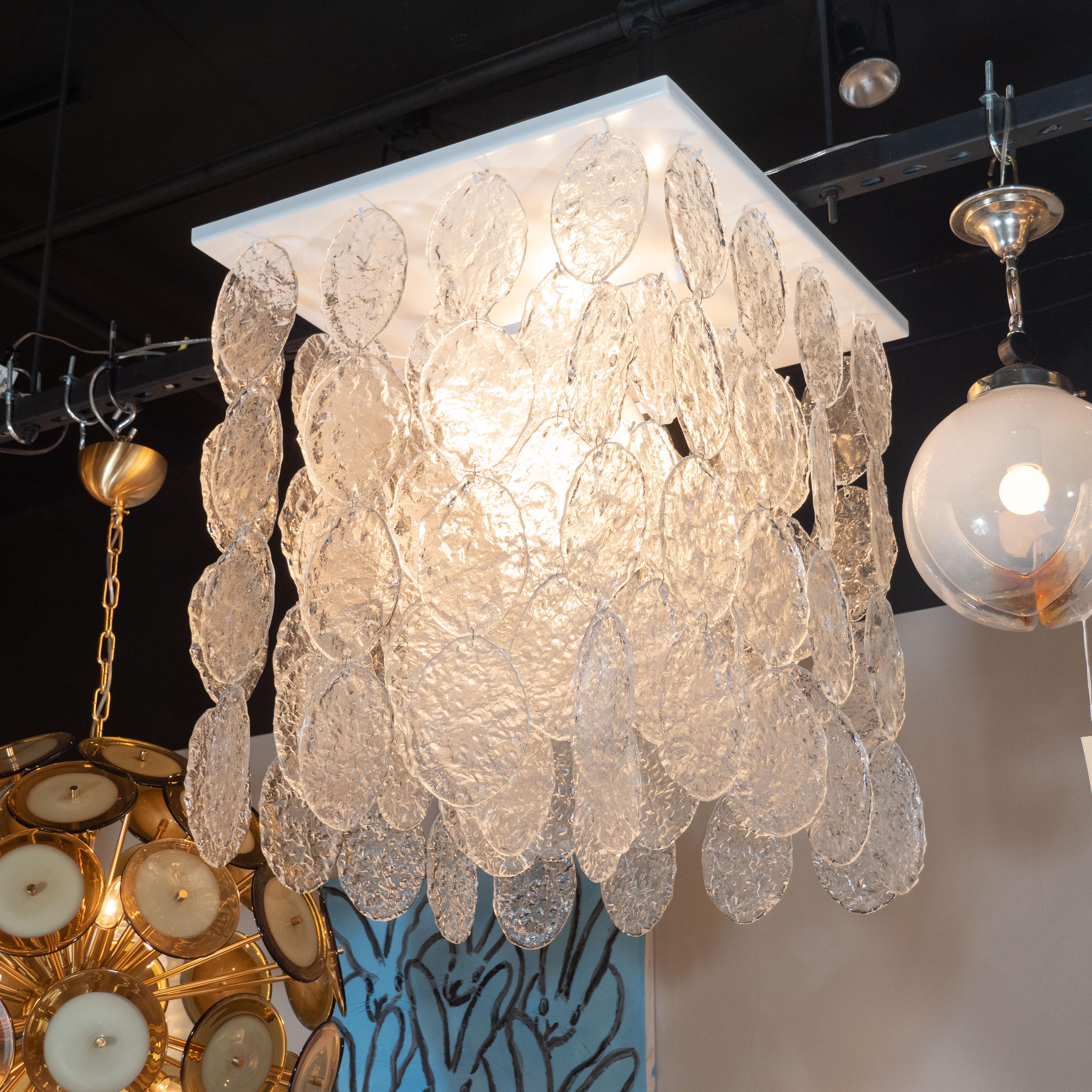 This dramatic chandelier was realized in Murano, Italy- the island off the coast of Venice renowned for centuries for its superlative glass production. It features an abundance of linked ovoid forms in highly textural handblown translucent Murano