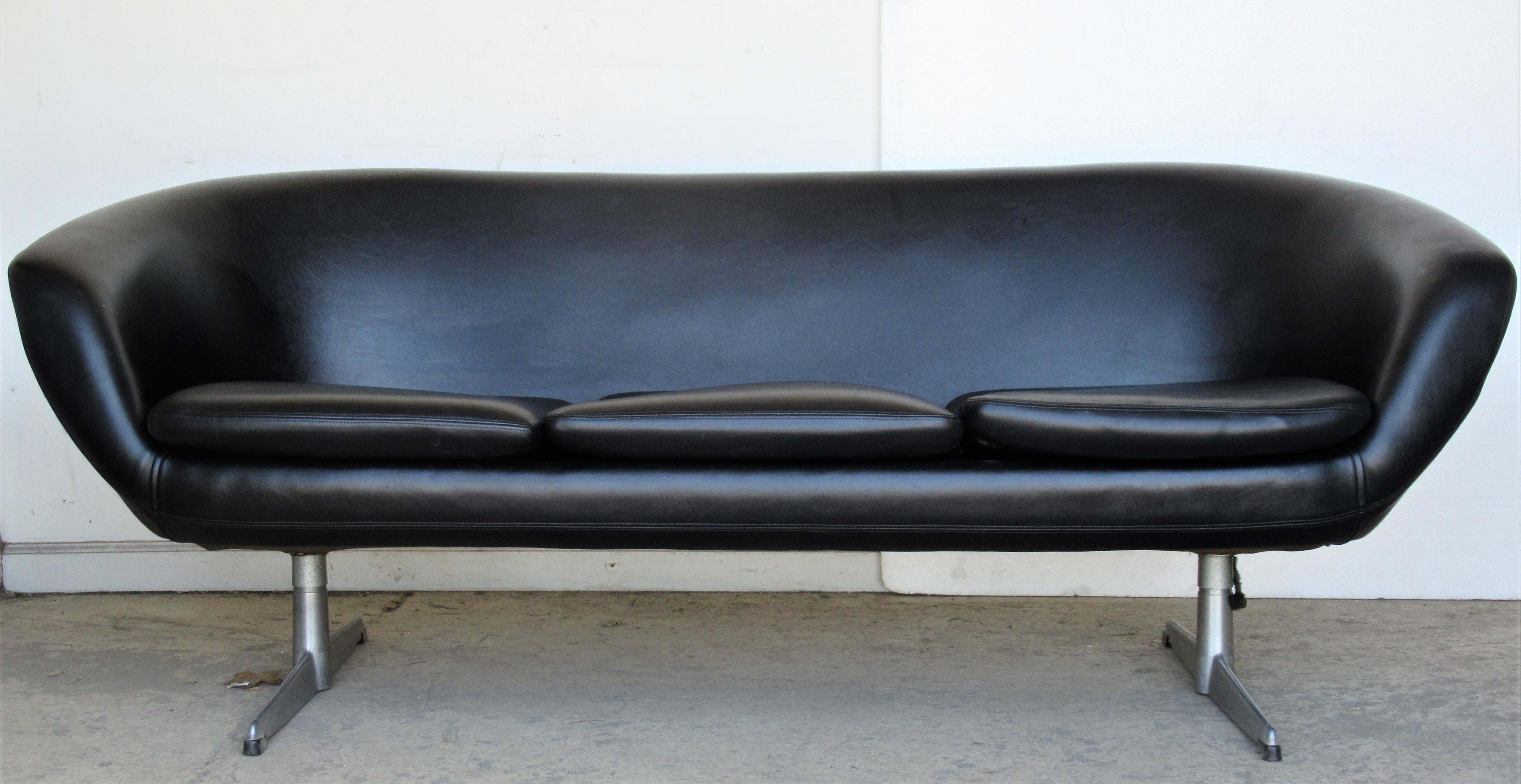 Modernist pod form three seat sofa with aluminum base by Overman, Sweden, circa 1960. The sofa is in very good all original condition retaining the stitched black leather like vinyl upholstery. Look at all pictures and read condition report in