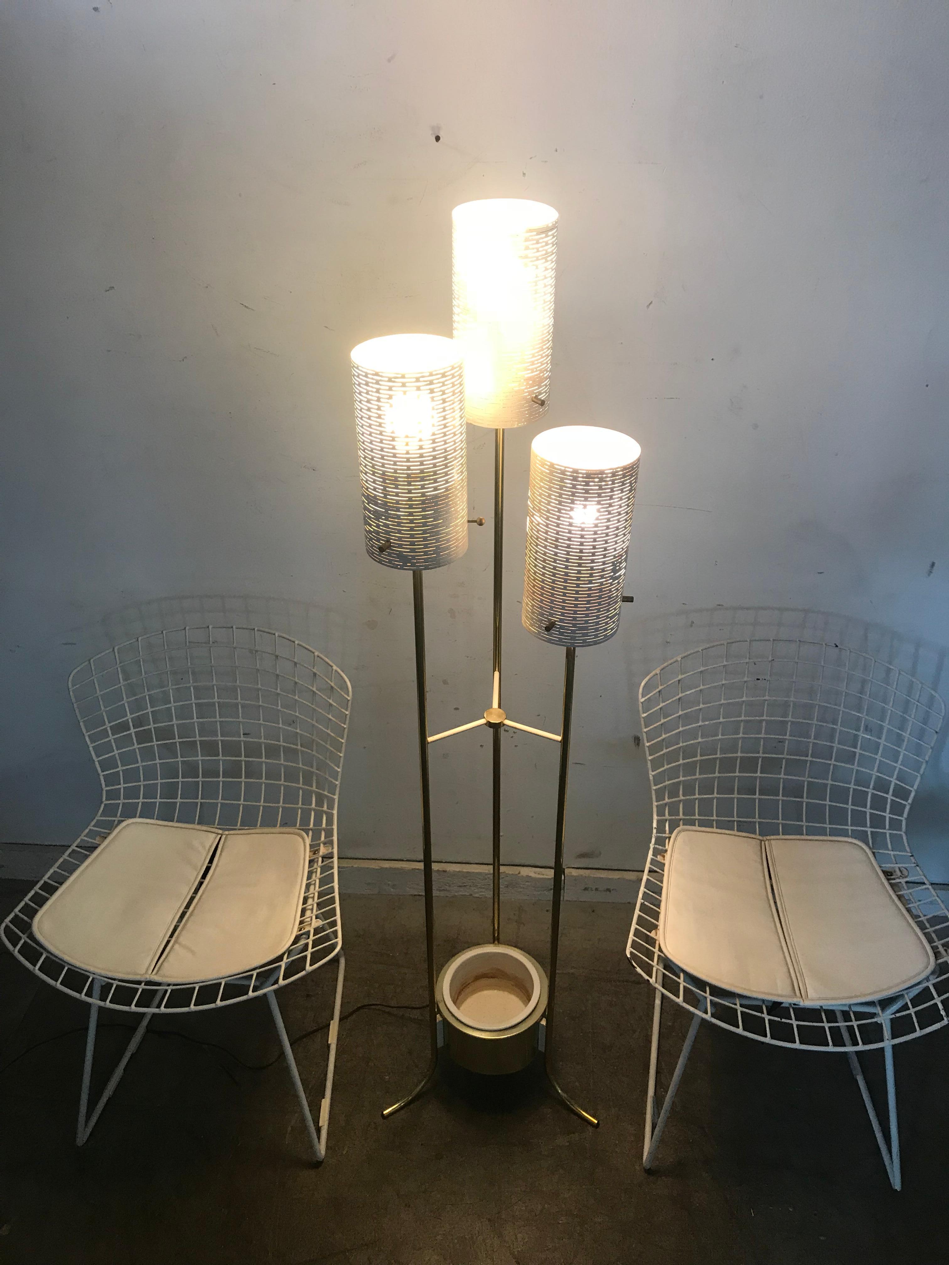 Modernist three shade brass and metal floor lamp with planter, classic Mid-Century Modern design, three perforated metal cylindrical shades, brass frame and pottery planter inset to bottom. Attributed to Stiffel Lamp Co, very reminiscent to the