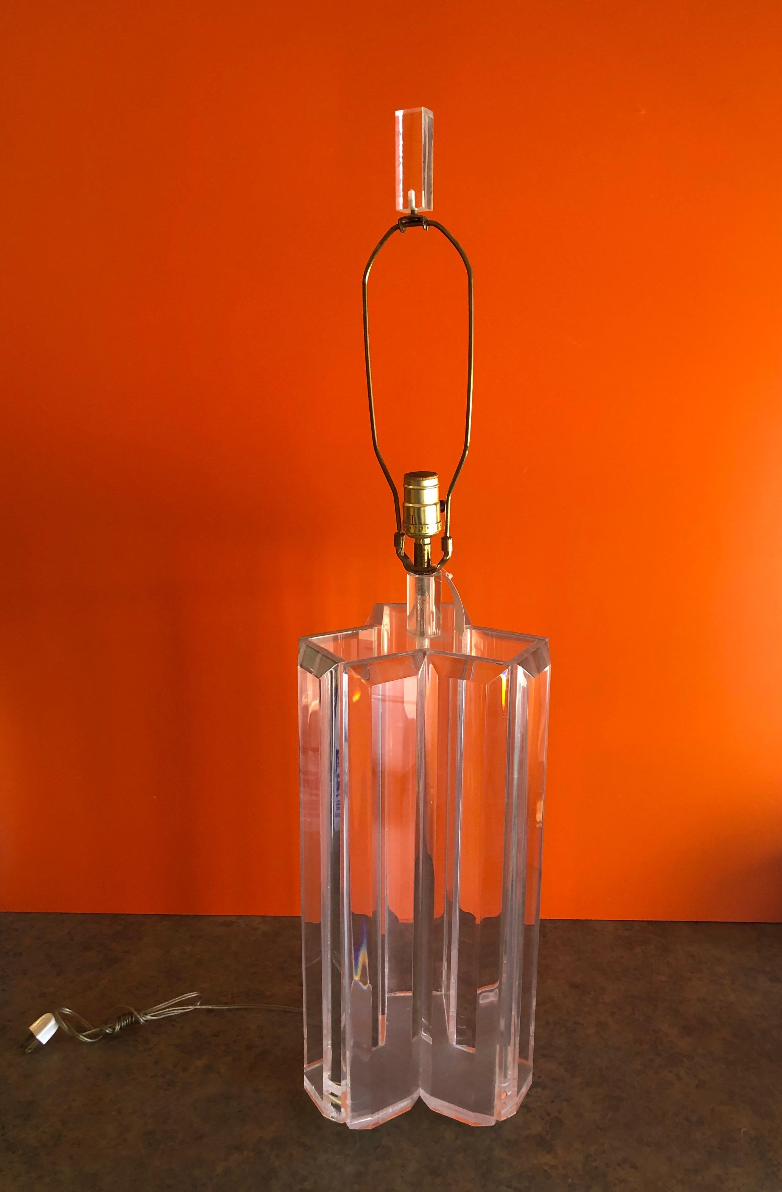 Super unique and rare modernist three sided Lucite table lamp in the style of Karl Springer, circa 1970s. The base of the lamp measures 9