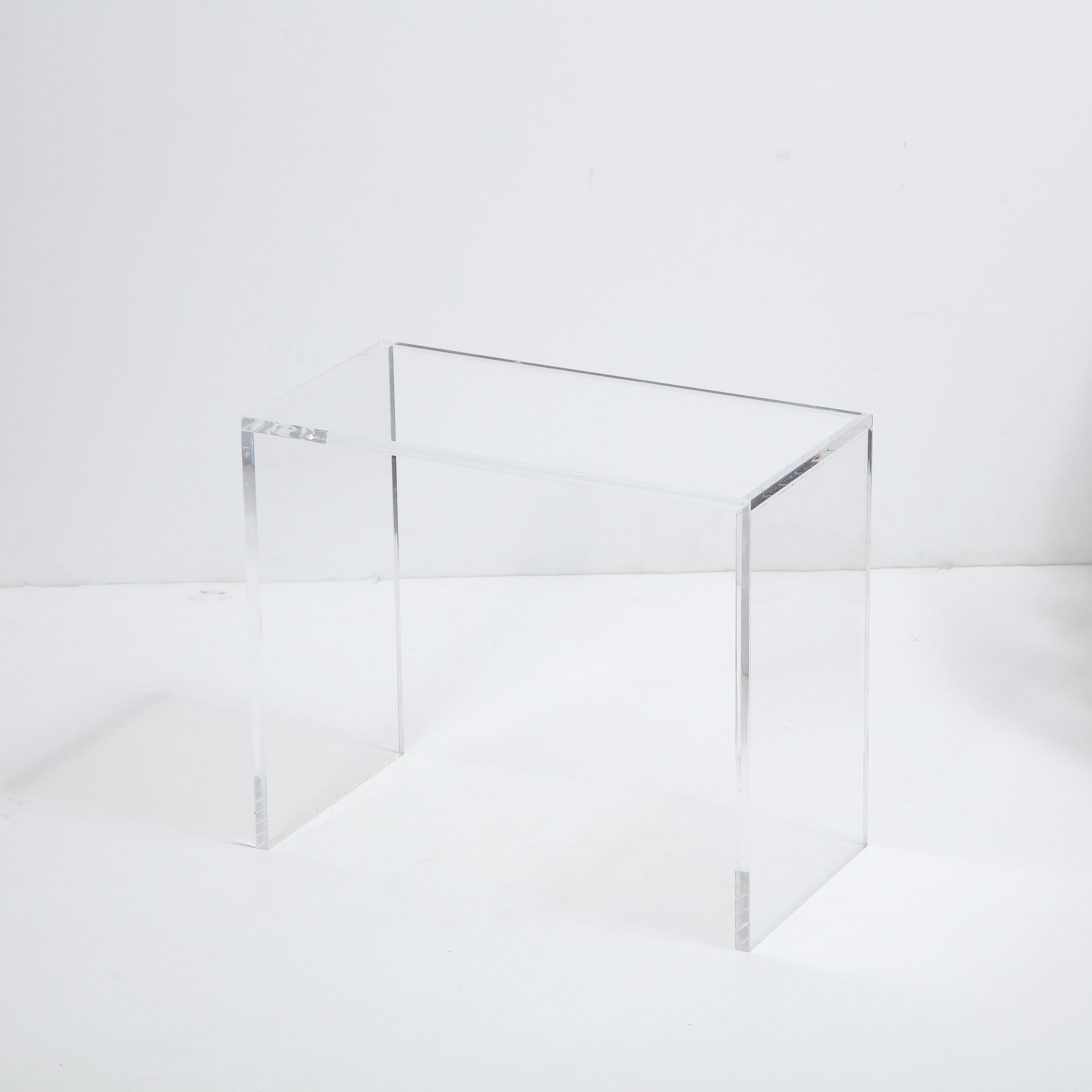 This refined side table/ pedestal features two rectangular legs in translucent Lucite that connect to a top of the same form and material creating a seamless Silhouette. With its clean modernist lines and Minimalist Silhouette, this piece promises