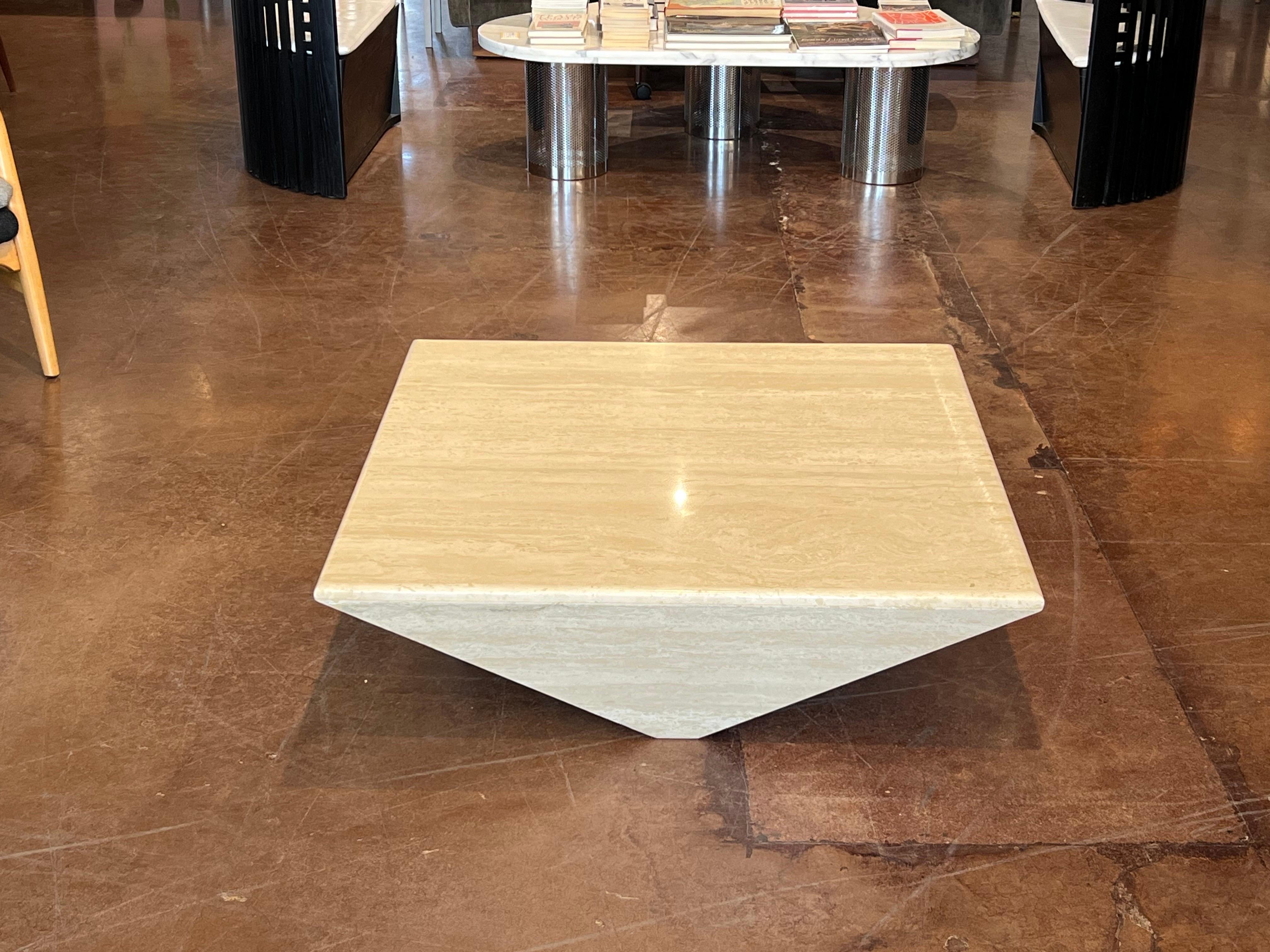 This Italian travertine coffee table is a stunning example of minimalist design, combining sleek lines with the natural beauty of stone. 

Measuring 13.50” in height and 40” x 40” across the top, this piece offers a substantial square surface while