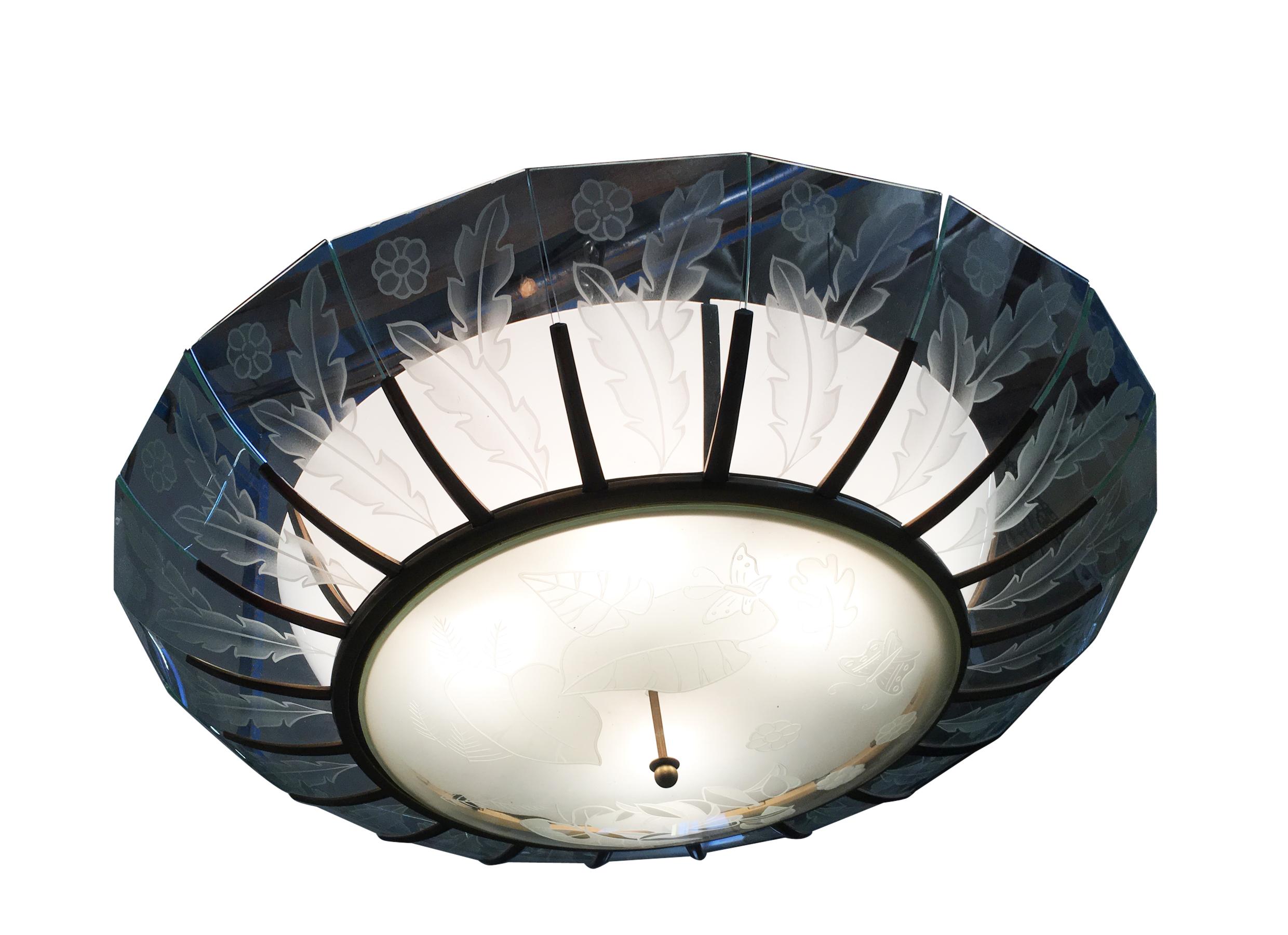 Unique custom made modernist bronze bowl chandelier made with a bronze frame and etched glass slats featuring a tropical floral motif and large etched glass dome bottom. This was purchased from the Art Deco Bullocks Wilshire.
We have four in