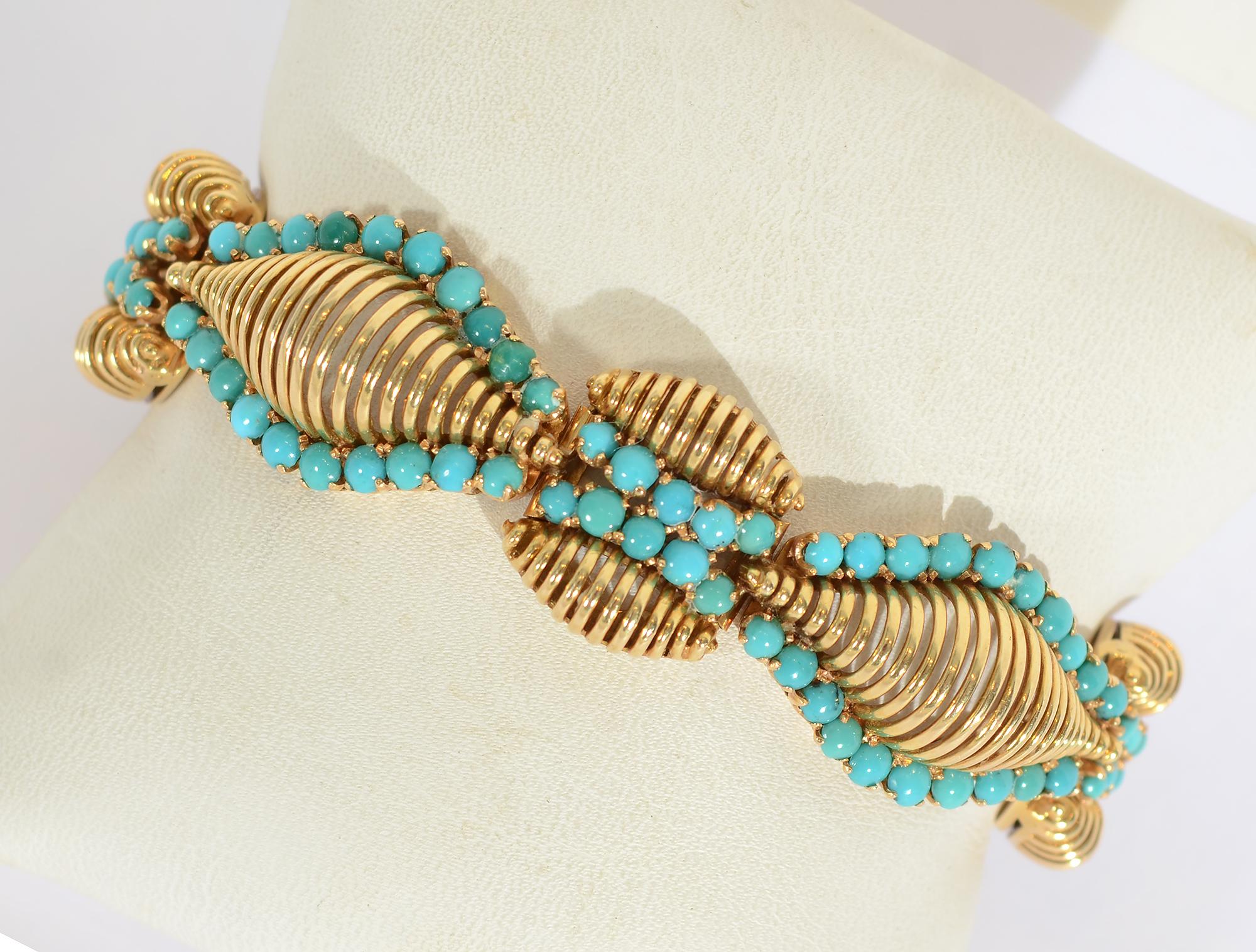 Most unusual bracelet of 18 karat gold and turquoise. The large gold links are of considerably greater height than the smaller gold links and undulating rows of turquoise. Both of these features give this bracelet a very strong as well as graceful