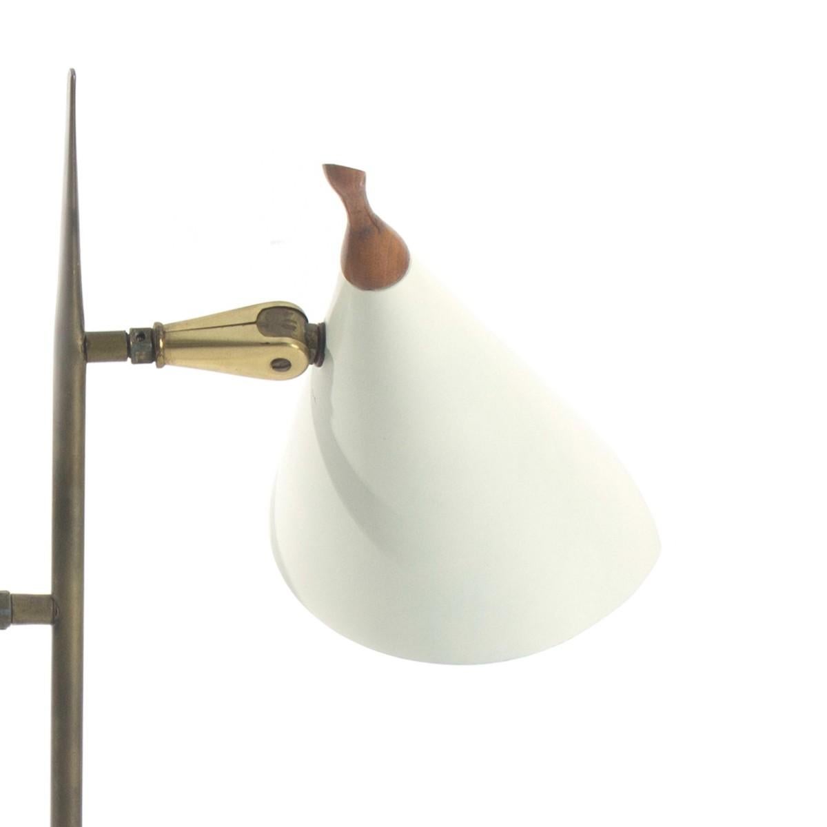 A brass, white metal and wood two-arm desk lamp featuring cone shaped shades, a square base and walnut finial. Likely made by Lightolier. USA, circa 1970.

Rewired; takes two standard US bulbs, 60 watts max each. 

Dimensions:
17.5 inches L × 6