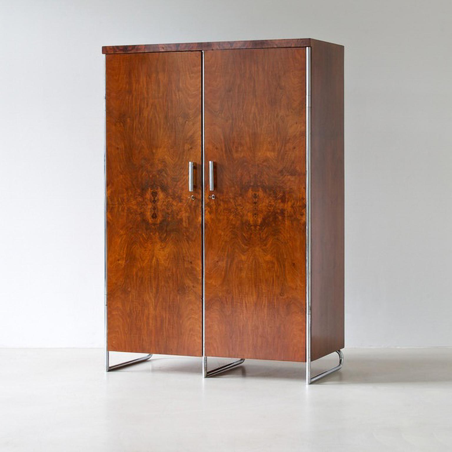 Modernist two door wardrobe designed by Hermann John Hagemann and manufactured by Thonet or Mücke-Melder, c. 1930. The wardrobe is made of chrome plated tubular steel and walnut veneered wood. 

This wardrobes are restored on request, delivery time